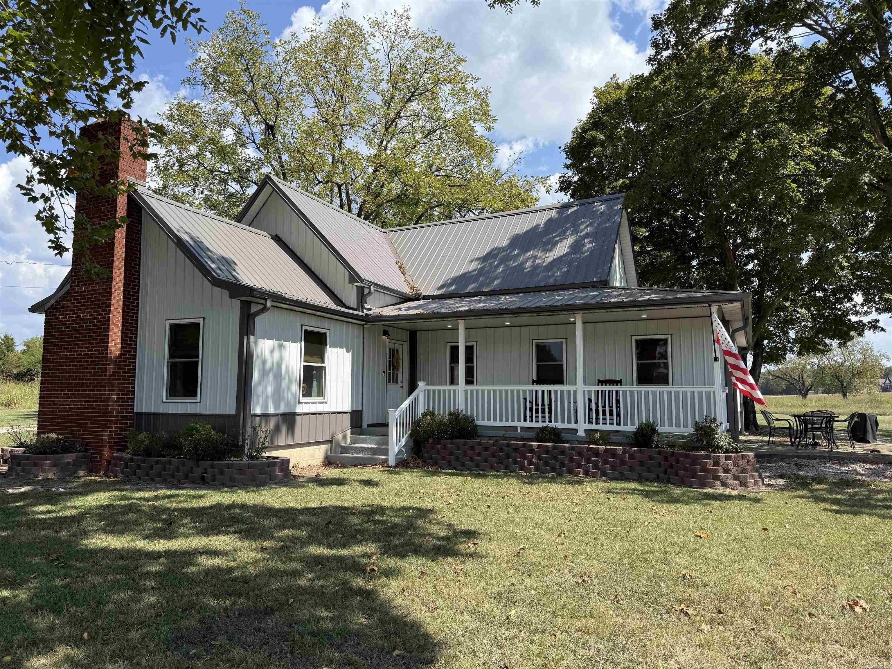 A completely remodeled older farmhouse in historic Mountain View, Arkansas, sits on 1.18 acres and offers the perfect blend of charm and modern comfort. The home features three spacious bedrooms with large closets, two beautifully updated bathrooms with walk-in showers, and a fully finished open-concept living area with a newly installed electric fireplace. The kitchen, bathrooms, and laundry room are highlighted with elegant granite countertops and new cabinetry, providing both style and function. The exterior has been refreshed with new siding, fresh paint, landscaping, and a durable metal roof installed in 2023. A new HVAC system was also added the same year for worry-free living. Outside, a 36 x 23 fully wired shop with a half bathroom offers exceptional space for projects or hobbies, while the detached two-car garage adds additional parking and storage. A storm shelter provides peace of mind during Arkansas weather. This unit has functioned as an Airbnb/VRBO the last year and a half, grossing over $30,000. Furniture is negotiable with the sale.