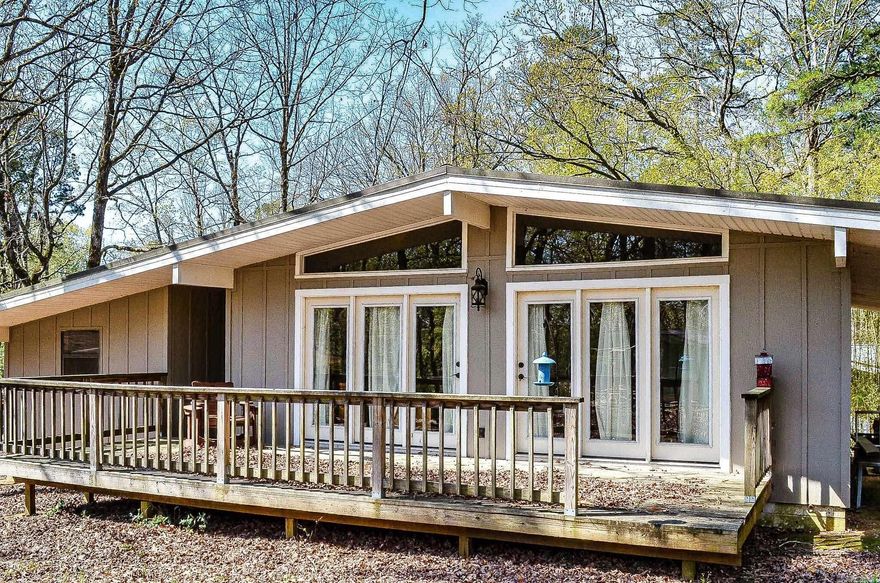 Surprise......the build date may say 1971 but this charming 2 bedroom 2 bath home has been totally renovated. Redesigned kitchen and both baths. Upgrades include granite counters, custom cabinets, wood floors, upgraded appliances, energy conscious windows and even a metal roof. Transoms above the French doors to the deck. Vaulted ceiling, upgraded ceiling fans and electrical fixtures. Hot Springs Village Property Owners Association has a new member buy-in fee of $2,000.00 due and collected at closing.