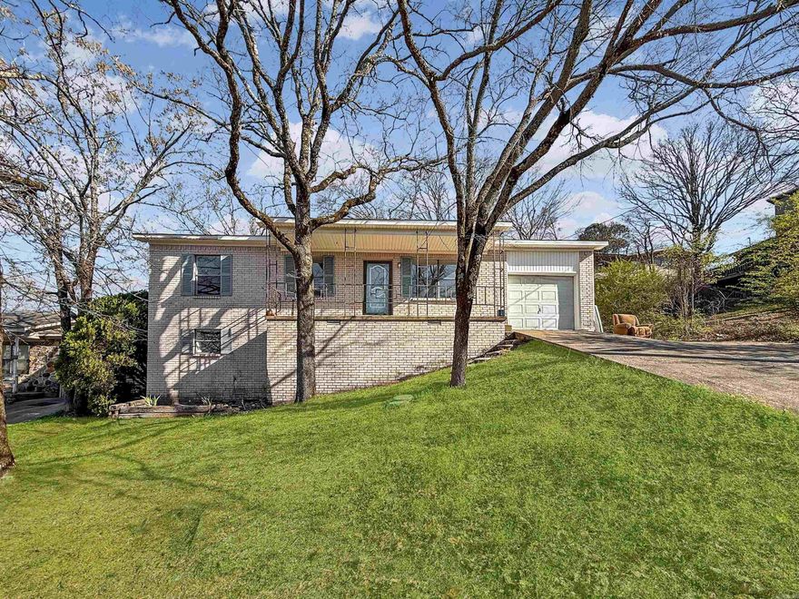 Spacious 4-bedroom, 2 and a half bath, 2-story home in North Little Rock, Arkansas. Features a versatile game room and 1 car garage. Situated on a sloping lot, this property offers unique elevated views of the surrounding neighborhood with a wooded back drop for added enjoyment. The back deck overlooks mature trees and a fun tree house. Home does need a little TLC but it's priced accordingly making it  great opportunity for buyers looking to personalize their space and add value. Quick access to the interstate. Nearby amenities include Burns Park with trails, parks, and golf! McCain Mall or Lakewood Village for shopping and dining options. Grass in exterior photos has been professionally altered to reflect spring. Agents see remarks for additional info and showing instructions.
