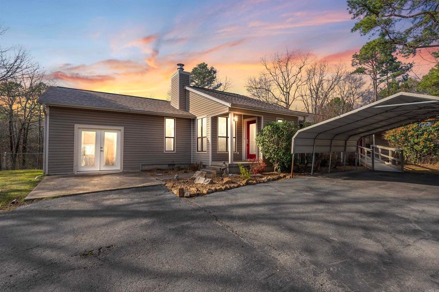 Discover your perfect retreat on this peaceful 2-acre property, ideally situated for nature lovers and outdoor enthusiasts offering privacy, convenience, and proximity to some of Arkansas’s best natural attractions. Upon entering, you’ll be welcomed by a cozy great room with vaulted ceilings, a wood-burning fireplace, and LVP flooring throughout the home. The open-concept dining and kitchen area is equipped with an electric range, microwave, dishwasher, refrigerator, and a walk-in pantry. Step outside to enjoy the back deck, complete with a fully screened-in porch, offering a tranquil space for relaxation overlooking a fenced area behind the home. The primary suite offers an en-suite bathroom featuring dual sinks, a makeup vanity, and a tub/shower combo. Renovated guest bedroom w/ en-suite bath plus an additional 2 bedrooms and hall bath. Attached to the home featuring its own private exterior access, is an in-law suite w/ flexibility of serving as an efficiency apartment offers a kitchen, den, bedroom, bathroom & laundry service. Covered parking for 3 spaces, previous storage space serving as a home gym w/ an A/C wall unit and additional parking pads (including one for an RV).