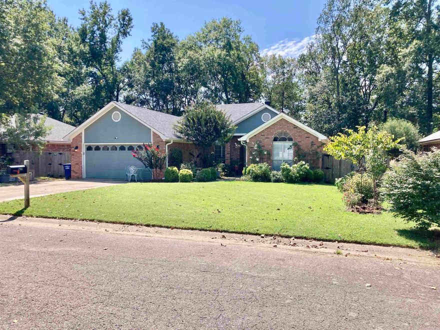 Conveniently located near schools. interstate, and restaurants! This wonderful home features many up-dates, including a new roof, new laminate floors and new granite countertops in 2021, new stove, microwave and dishwasher in 2022. The open floor plan, vaulted & tray ceilings, large pantry, decorative brick fireplace, bonus mudroom/small office all add to the charm of this home.  Relax on the spacious back deck in the fully fenced yard or enjoy organizing your things in the large storage building. Refrigerator conveys!