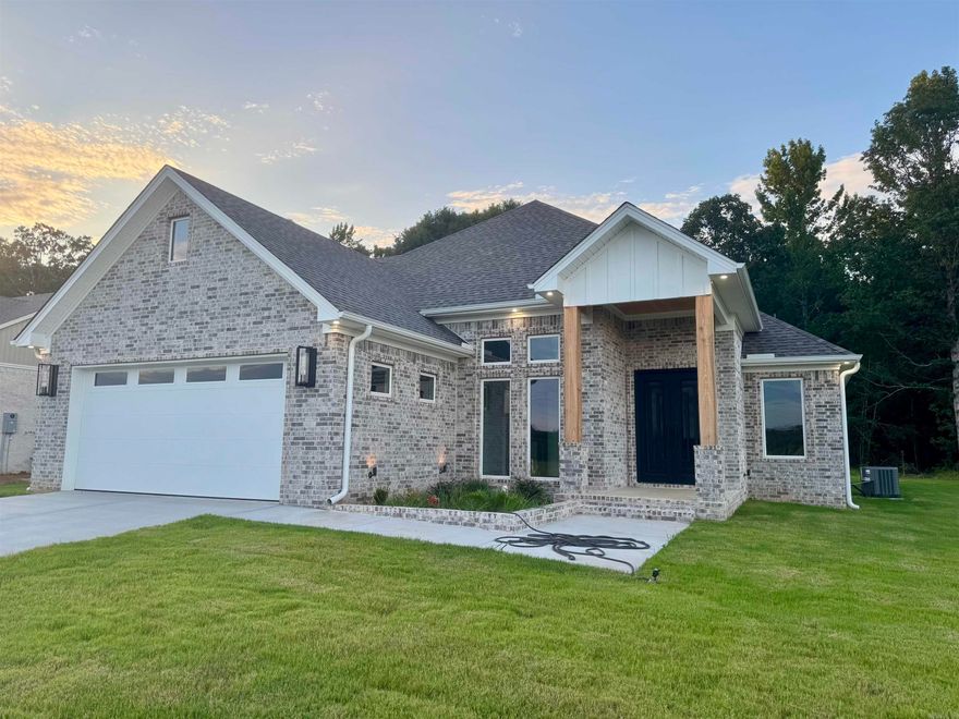 Step into this beautifully designed 4-bedroom, 2-bathroom home where every detail is thoughtfully curated—from the 12-foot ceilings to the designer finishes throughout.  At 2,400 sq ft, this home offers an ideal layout for both comfort and style. The chef’s kitchen is a true focal point, featuring quartzite countertops, sleek custom cabinetry, and statement pendant lighting that creates an elevated, modern atmosphere.   The open-concept layout flows effortlessly into the living and dining spaces, where oversized windows bring in natural light and accentuate the soaring ceilings.  Retreat to the primary suite, where you'll find a stunning custom accent wall, spacious layout, and a spa-style bath with upscale touches throughout.  Outside, the home boasts bold curb appeal with a stylish brick and mixed-material façade, a covered entry with wood beam details, and a spacious driveway leading to the 2-car garage. Backed by wooded land, it offers a sense of privacy.  Nestled in a quiet, new development, this home is perfect for those looking to balance modern design with peaceful surroundings.