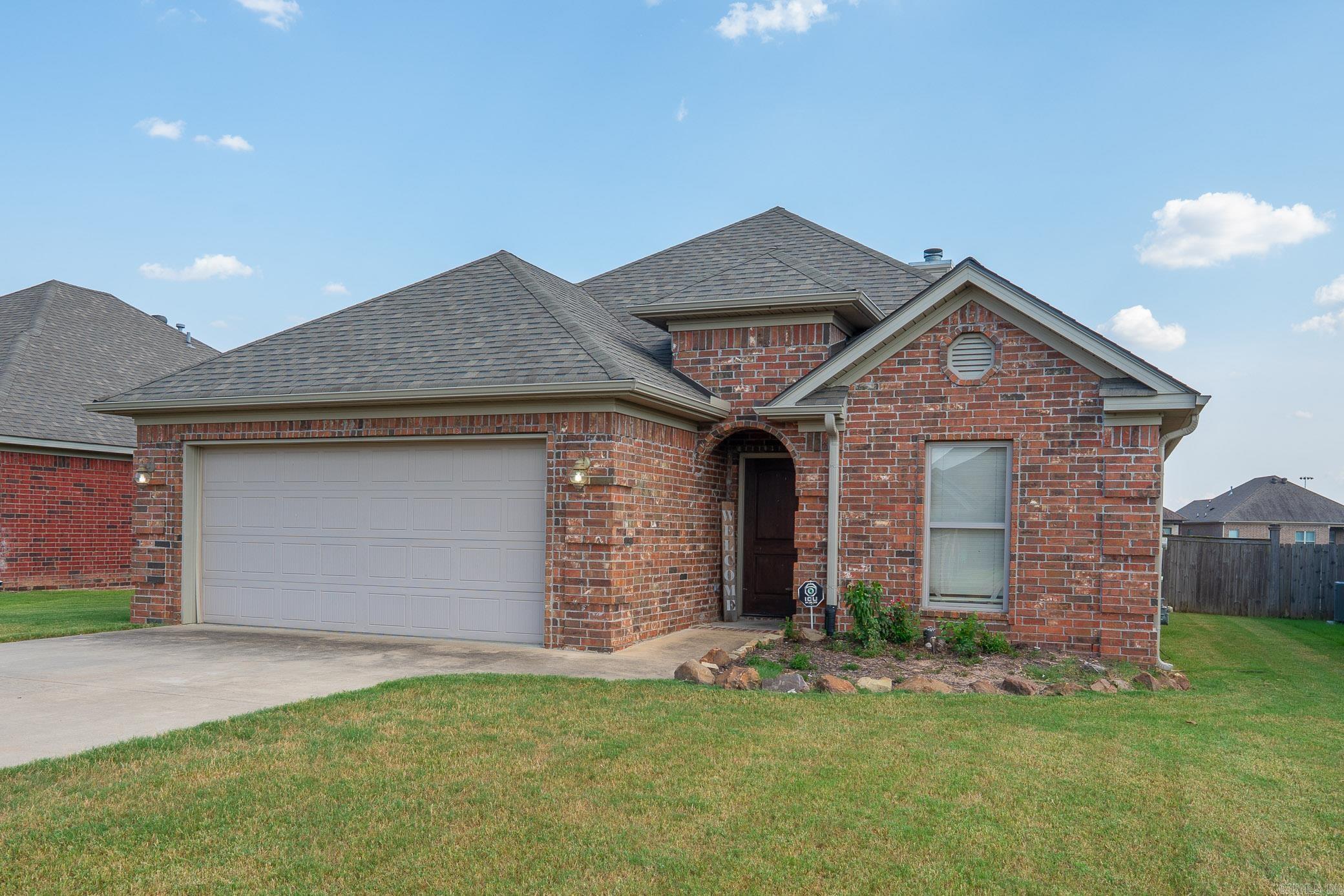 Charming One-Story Brick Home in Country Club of Arkansas Subdivision Step into an inviting open-concept living space where 10-ft ceilings with a wood-burning fireplace. The kitchen is a chefās delight, equipped with stainless-steel appliances, a pantry, and premium granite countertopsāperfect for both casual meals and entertaining. Throughout the home, enjoy natural lighting, engineered wood floors, and graceful double crown molding for added refinement. Retreat to the luxurious primary suite featuring a dual-head shower, double vanity, and a spacious walk-in closet. Outside, relax on the covered back patio or step out into your fully fenced shaded backyard with direct access to a walking trailāan ideal blend of indoor comfort and outdoor enjoyment. Built in 2014, this 1,537-sq ft home offers modern design and thoughtful details on a level lot. SEE AGENT REMARKS