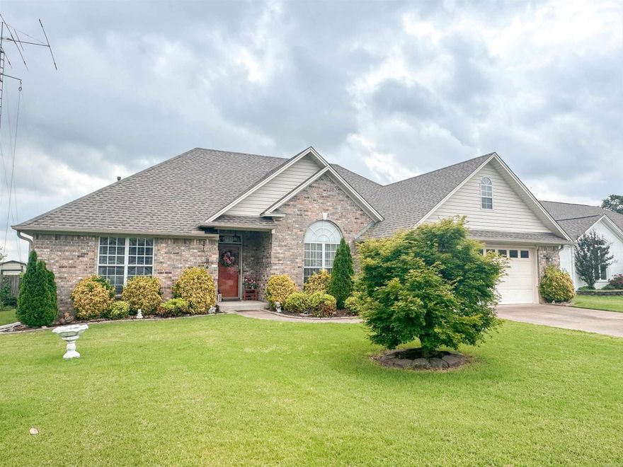 Beautiful well-maintained home with an open foyer/living room/formal dining area, crown molding, wood floors in the living, dining & primary rooms, cozy gas log fireplace, and an updated kitchen with quartz countertops & new tile. This split-floor plan has a lovely primary suite with tray ceilings, two walk-in closets, jetted tub, separate shower, double vanity & nice linen closet. The separate guest rooms have laminate flooring with a guest bath in between. The backyard includes a bald eagle storage shed with work bench and covered back porch, sprinkler system in both yards, & new leaf guards on the gutters. The new roof was installed in December of 2024. Make this your new place to call home!