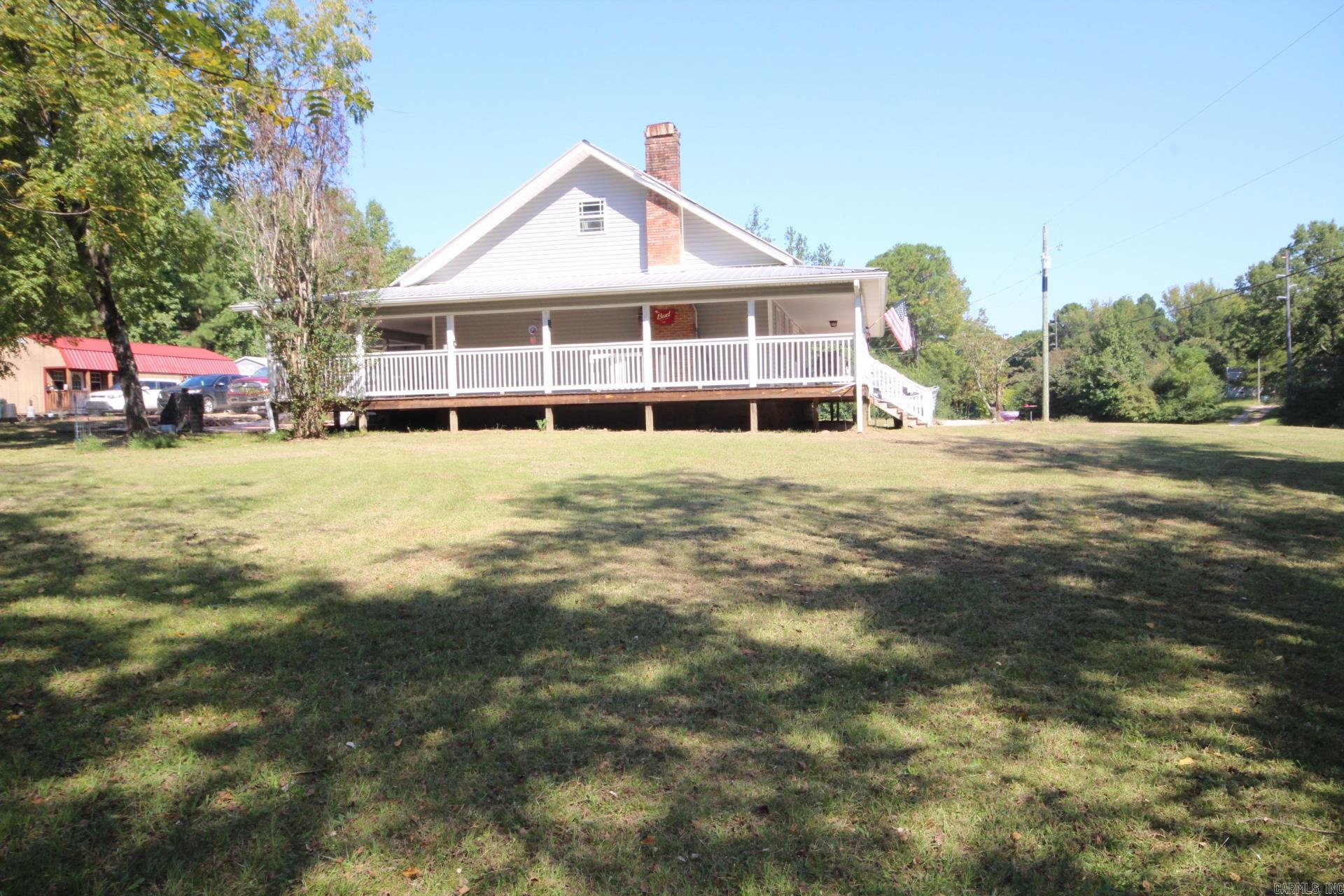 JUST A SHORT DISTANCE TO CRATER OF DIAMONDS STATE PARK, LAKE GREESON AND LITTLE MISSOURI RIVER. 3 bedrooms, 2.5 baths with approx. 2512 Sq. Ft. of livings space. Kitchen is spacious with lots of cabinets, concrete counter top and a wood epoxy Island. Large living area, and a large upstairs bonus room. Home features a covered wrap-around porch. Central A/C & Heat. Metal Roof. Range, refrigerator and washer/dryer conveys with sell of home. Property has a storm shelter, two outbuildings and pond.