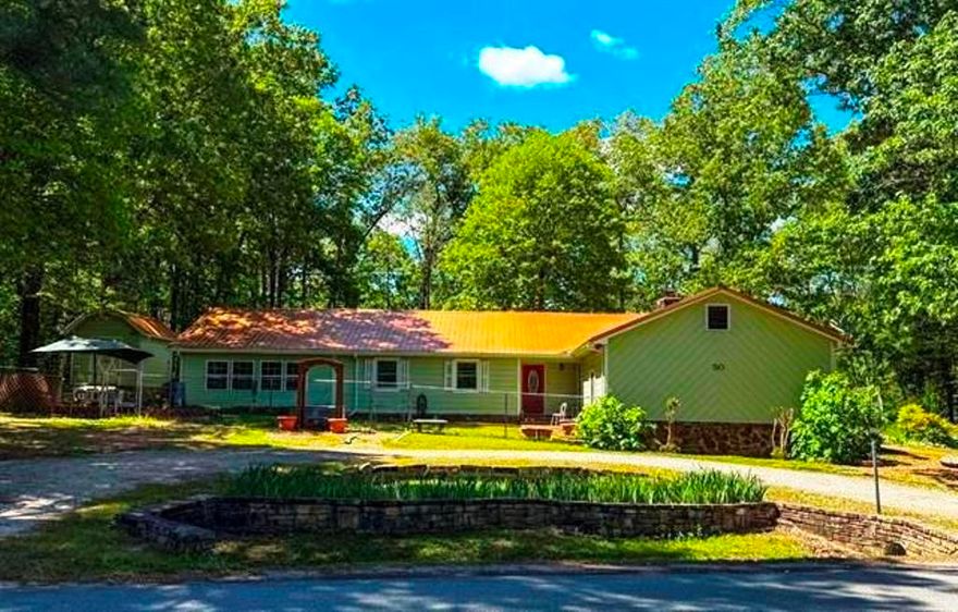 Custom Cherokee Village home on approx. 0.76 acres m/l, within walking distance to the South Fork of the Spring River. This well-maintained 3 bed, 2 bath home offers comfort, accessibility, and great outdoor living. Inside features a spacious living room with vaulted ceilings, real wood walls, a beautiful beam, and gas log fireplace, plus custom flooring throughout. The kitchen includes a bay window dining area and garden window over the sink for natural light.  The oversized master suite has vaulted ceilings and a large bath with walk-in shower plus direct access to the sunroom. A flexible office/bonus room connects to the laundry room with potential half bath hookups. A second bedroom also opens to the sunroom for great indoor-outdoor flow.  Wheelchair accessible with a 2-car garage and storage room. Outside is surrounded with landscaped views, multiple sitting areas, and a 600 sqft shop with RV hookups and lean-to. Ideal for full-time living, vacation, or investment.