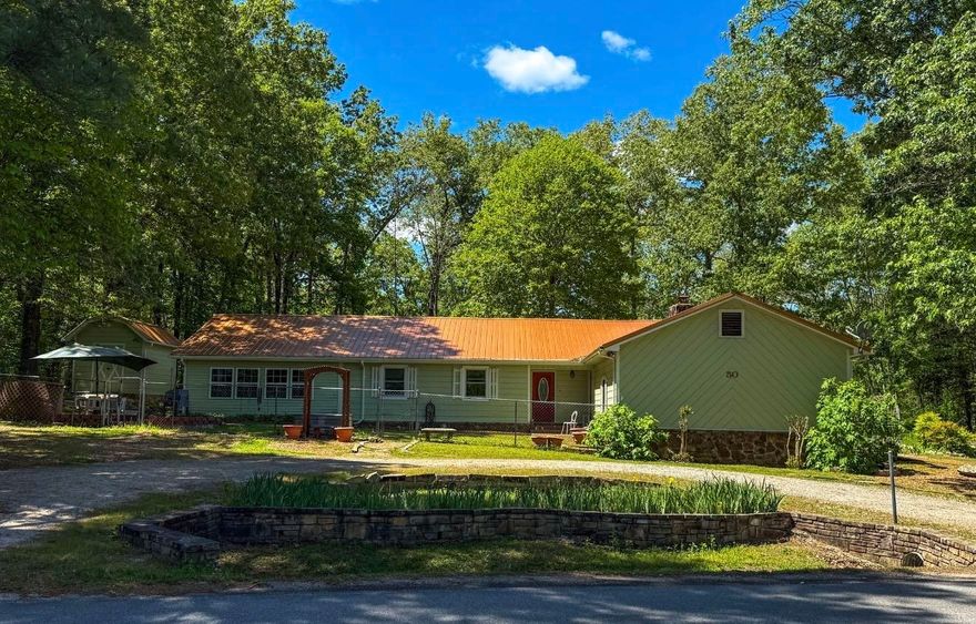 Custom Cherokee Village home on 0.76 acres m/l, within walking distance to the South Fork of the Spring River. This well-maintained 3 bed, 2 bath home offers comfort, accessibility, and great outdoor living. Inside features a spacious living room with vaulted ceilings, real wood walls, a beautiful beam, and gas log fireplace, plus custom flooring throughout. The kitchen includes a bay window dining area and garden window over the sink for natural light.  The oversized master suite has vaulted ceilings and a large bath with walk-in shower plus direct access to the sunroom. A flexible office/bonus room connects to the laundry room with potential half bath hookups. A second bedroom also opens to the sunroom for great indoor-outdoor flow.  Wheelchair accessible with a 2-car garage and storage room. Outside is surrounded with landscaped views, multiple sitting areas, and a 600 sqft shop with RV hookups and lean-to. Ideal for full-time living, vacation, or investment.