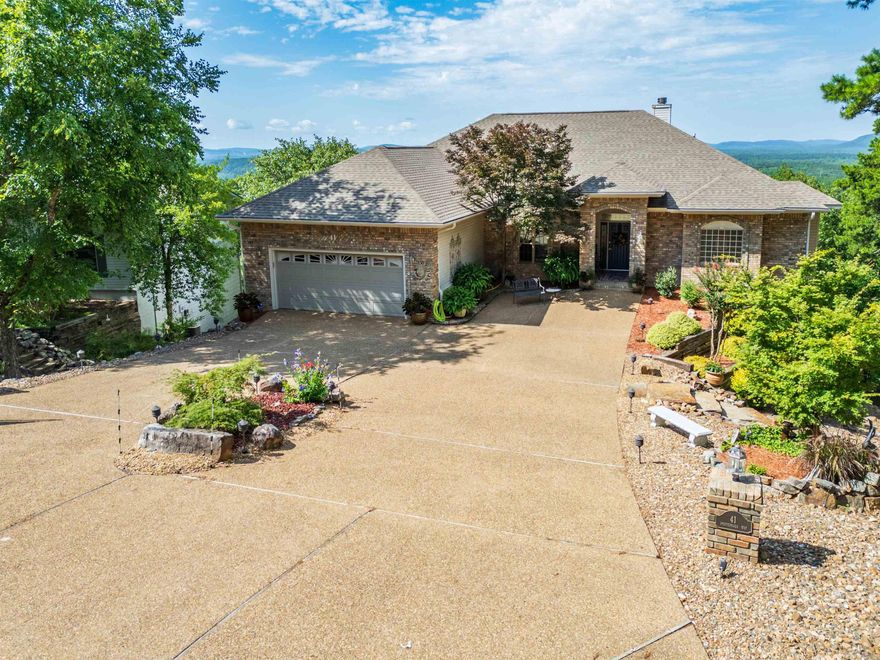 Front elevation - VERY inviting, but wait until you see the view! This one has a "charge for admission view".   It could mess with your head and tell you that you never want to leave!  Although there's slope enough for 2 levels, the driveway is very gentle - near flat. Enter to a wall of windows which draw you to the view & covered deck - all seasons spectacular! This charming custom home offers most everything that all retirees coming to beautiful Hot Springs Village hope to find - beautiful home on a beautiful lot with grand amenities galore. Whatever you were expecting, you must check out this one before deciding. Call Jane for a private showing. There's no substitute for seeing in real life! SEE AGENT REMARKS