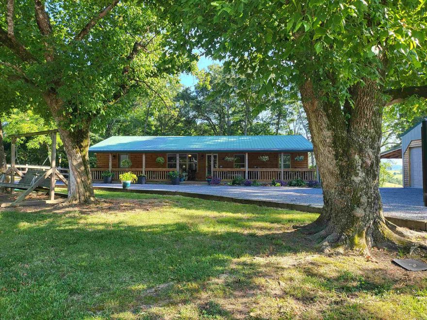 Beautiful renovated 2-bedroom, 2-bath home nestled in the Ozarks sits on a 1-acre lot, & offers the perfect blend of modern amenities & rustic charm. Located near the captivating Buffalo National River, it embraces the beauty of nature & its only 4mi to town. Includes a new metal roof, new log & metal siding, & inviting front & back porches with stunning views of the surrounding landscape. Cozy up by the gas fireplace on cool nights & rest easy with a reliable 22K generator for backup power. Renovated with care, this home boasts new windows & shades, PEX plumbing, updated wiring with 200 amp, & new light fixtures. Move-in ready & impeccably maintained, the en-suite bathroom offers a luxurious Jacuzzi tub, while the spacious laundry room provides ample storage. The property is fully fenced, & includes a RV hookup, a 3-car garage, a carport, & a storage shed. Enjoy farm work in the garden space & create a mini-hobby farm with room for goats or sheep. This turnkey treasure comes complete with kitchen appliances. Enjoy hiking, fishing, canoeing, & hunting amidst the wonders of the Ozark Mountains. Embrace a life of peace&beauty in one of the most enchanting regions of the United States