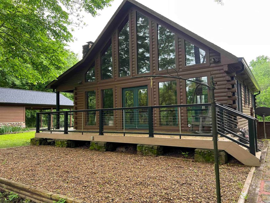 Riverfront cabin on the world famous Little Red River. This home has it all - Property includes 2 Lots on approximately 2 acres, not in a subdivision, vaulted wood ceilings, cedar walls, real hardwood floors, dining area with river view, large living area with stacked stone wood burning fireplace, picturesque windows looking out to the river, master bedroom with a view of the river, covered front porch, 2 outdoor patio areas perfect for entertaining, plus the private boat dock is completely floored but is framed for a boat slip, this home also has a 2 car covered parking with a storage area that could be converted to bunk house, lot is private with large undeveloped land across the river and to the east and the lot to the south is included with the home, furnishings negotiable