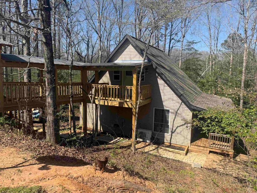 Tucked away at the end of a quiet cul-de-sac, this charming 2-bedroom, 1.5-bath A-frame home offers the perfect blend of privacy, style, and comfort. With its striking architecture and inviting modern rustic feel, this home is designed to impress from the moment you arrive. Step inside to an open-concept layout that seamlessly connects the kitchen, living, and dining areas—ideal for entertaining. Warm finishes, natural textures, and thoughtful details create a cozy yet updated atmosphere throughout. Outside, the expansive wrap-around deck is the true highlight, providing the perfect space for morning coffee, evening gatherings, or simply enjoying the peaceful surroundings. Whether you’re looking for a full-time residence, or investment opportunity, this unique A-frame delivers character, charm, and a setting that’s hard to beat. Schedule a showing today.