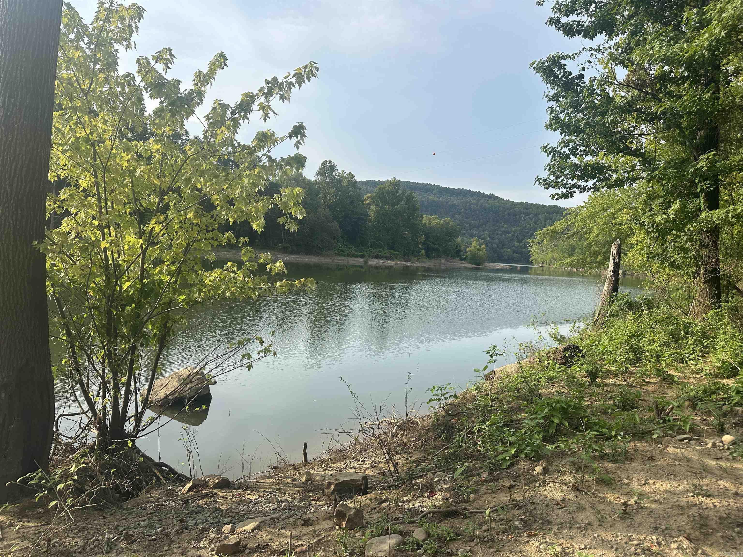 Perfect Mini house or treehouse location right on the banks of the Middle Fork Little Red River, also known as Greers Ferry Lake, which it backs up most of the time, but the property goes upslope from the Water and has enough of a flat to build your dream Mini house with an awesome view of the waters. Whether you're picturing a cozy cabin getaway, a fishing escape, or a peaceful place to unwind, this property delivers a level of serenity you have to see to believe because this property offers your own place to put in for kayaking and fishing and enjoy wildlife galore -deer, birds, and river creatures, a nature watching paradise. It's off-grid, but there's one property you might ask for right away: crossing, but not a guarantee, or simply putting up solar panels and searching the bluffs above for possible springs or a weekend mini-house getaway.