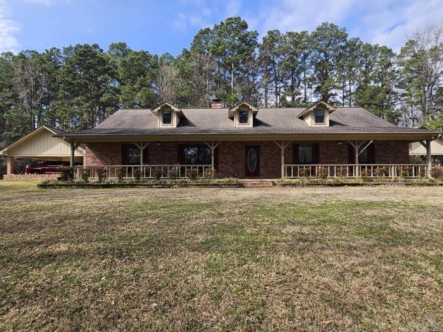 This 4 BR/2 BA ranch-style brick home offers 2,376 sqft of space, situated on a 3-acre (M/L) lot just outside Camden city limits. Enjoy the convenience of city water, natural gas, underground utilities, & ARIS internet. Inside, you'll find hardwood & tile flooring, custom cabinetry, built-ins, & quartz countertops. The thoughtfully-designed kitchen also features a pantry w/ drawers & a workspace/desk area. A bonus room provides the option for a 4th bedroom, office, or media room. The living room boasts a vaulted ceiling & a woodburning fireplace w/ insert, while the master suite includes a 3'x6' walk-in shower & double closets. This property truly shines outdoors w/ a fully-equipped outdoor kitchen featuring stainless steel cabinets, an 8-ft hot tub, TV, & dining bar. The landscaped grounds include a patio/breezeway, sprinkler system, greenhouse, small pond, & multiple outbuildings - a 24x40 heated/cooled shop w/ half bath & attic, a 30x60 pole barn, & additional storage. A three-car attached garage w/ floored attic provides even more storage. Additional acres are also available for future purchase. This one-of-a-kind property offers space, privacy, & endless amenities.