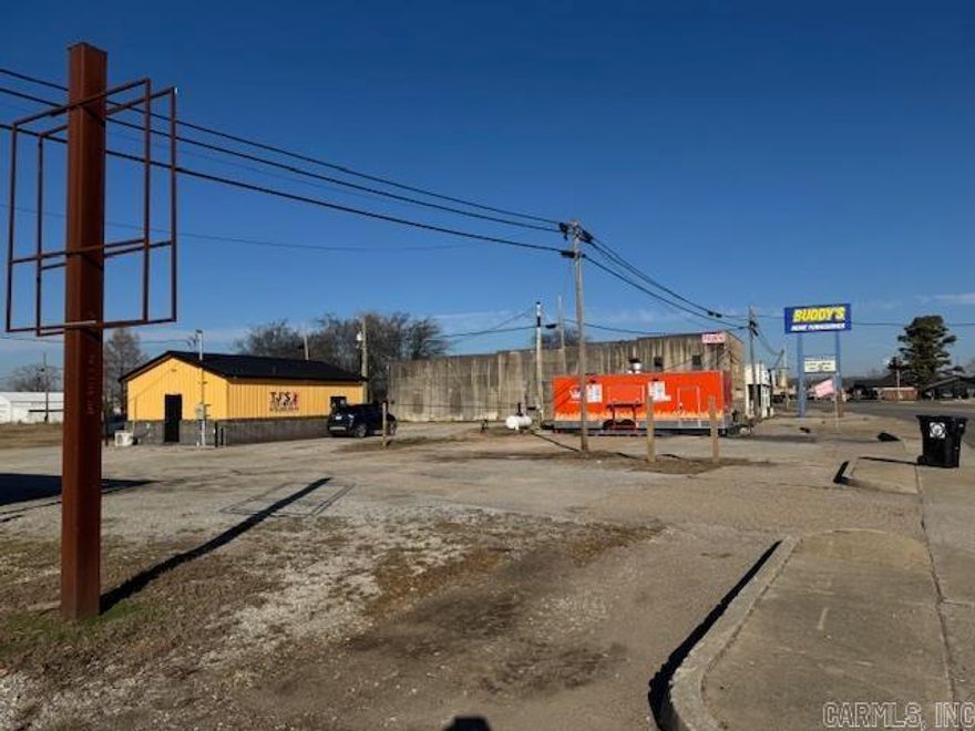 1.5 ACRES W/BLDG & LOTS OF OPTIONS!!  1.49 acres m/l with US Highway 67 South frontage. Acreage has road frontage on 3 sides and has a 600 square foot building that currently houses a very popular Tex Mex restaurant. Building was built in 2021 and is open floor plan with half bath. Some equipment conveys.  There is also a Japanese Food Truck that rents a spot. Two tenants currently paying rents with room for more. Property has 220 electric, city water and city sewer. So many options and so much potential with this high visibility property!