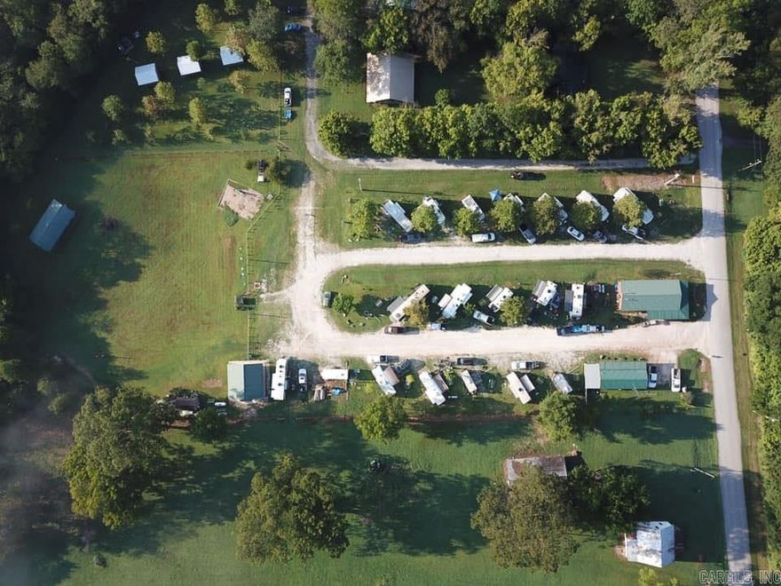 Own a slice of Gilbert with this 6-acre RV campground and cabin property just three blocks from the Buffalo National River access point. Bordering national park land and located in city limits, it’s an outdoor lover’s dream! The property features a 15x40 one-bedroom cabin that is fully furnished with full amenities, excellent insulation, and a covered porch. There are also three 12x16 primitive cabins, each with two beds, air conditioning, and a refrigerator. For RV travelers, there are 17 RV sites equipped with electrical boxes and water hookups. The main building is a 24x48 office/store with concrete floors and a covered porch. Additional facilities include a 24x24 shower/restroom building, a 20x40 pavilion with electricity, and a tent camping area with power. The property also has two septic systems, city water, a 160-foot irrigation well, and a 20-foot windmill. With plenty of space to add more cabins, recreational buildings, or other amenities, this campground is ready for guests and offers endless possibilities. Contact us today to schedule a showing!