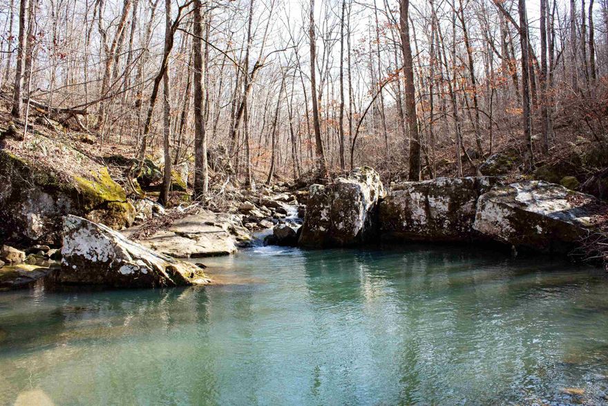 Off the Grid Cabin with year round Sulphur Spring Branch Creek located within a few feet of front door!  Are you Ready: - to write your novel? -Get to know your soulmate better? -Reenergize your soul? -Kill a Buck, Turkey, Squirrell? -Run a Trot Line with you on the end of it? A year round pool is located just off the cabin's back porch a perfect place for relaxing in the super clean water running through the rocks.  The miners cabin has Breaker box, wiring, satellite dish, balcony, upper room, and back porch.  Shower and Sink are ready for water hookup.  12 acres has a locked cable entrance and a low water crossing.  Did I mention you can hear water from the cabin year round running through the rocks? Owner has sealed up all the joins this place is ready for a generator, couch, bed, and you to occupy it.