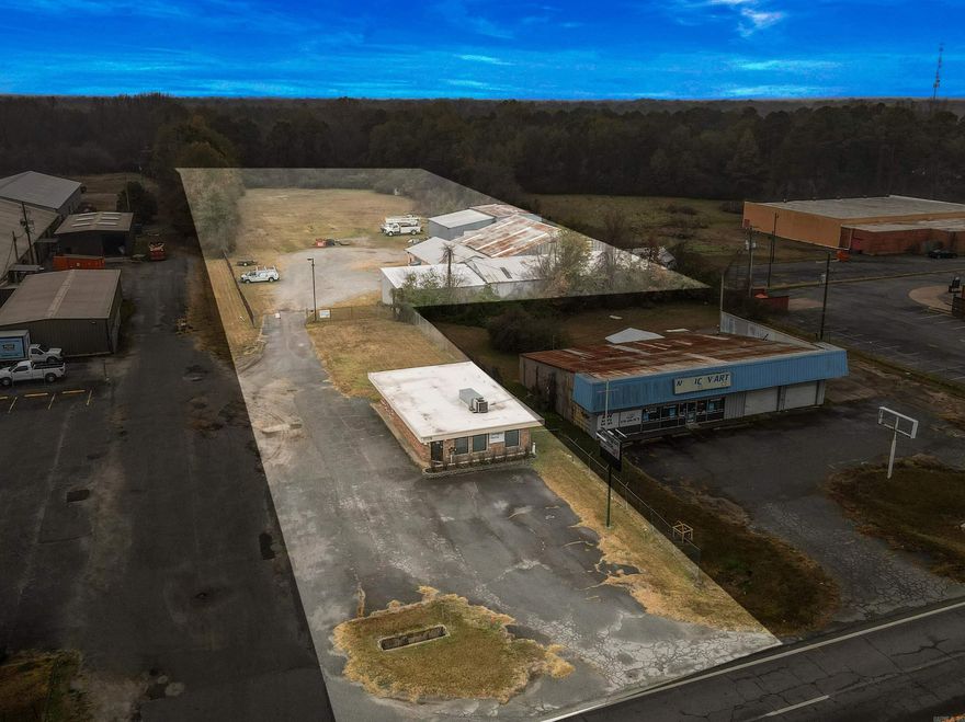 Excellent commercial opportunity featuring prime road frontage and high visibility on 3.72 acres. This versatile property includes a well-appointed office building and three secure shops/warehouse buildings, making it ideal for a wide range of business operations. The 1,269 SF office offers a professional layout with a waiting area, multiple workspaces, conference room, break room, storage, and two half baths, along with two separate entry/exit points. The main shop (12,328 SF) is designed for heavy-use operations and includes three oversized bay doors, multiple 120/240V power panels (single-phase and 3-phase), half bath, ice machine, office space, and two large warehouse areas with shelving. Shop #2 (4,000 SF) features a 12x12 bay door, 120/240V single-phase power, and shelving. Shop #3 (1,350 SF) includes a 12x10 bay door, an extra-secure room, and shelving. All shops and the large parking and equipment yard are fully fenced, providing excellent security. The property offers ample room for additional buildings or warehouse expansion. With outstanding visibility, secure infrastructure, and room to grow, this property offers tremendous potential for a wide range of commercial uses.