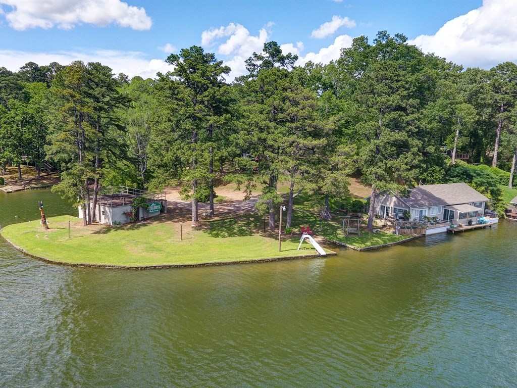 This Beautiful Piece of Property offers 487' of Shoreline on Lake Hamilton. It boasts AMAZING VIEWS with Mt. Riante in the Backdrop. Located on the Very Private Marion Anderson Cove, a Quiet Street shared with only 3 other homes. The Original Home has been taken down and utilities are in place to build a New Main Residence. A Quaint Quonset Hut is located on the Water's Edge. You will love the Rooftop Patio on the Boat Dock! Call Today for More Information!