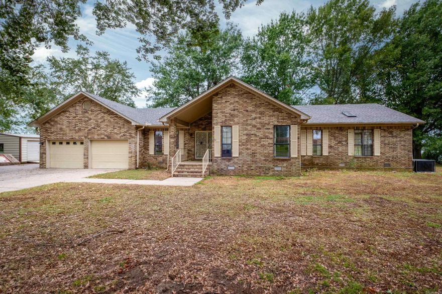 Discover the potential of this lakeside property with solid updates already in place! Featuring a new roof and one new HVAC unit, this 3-bedroom, 2.5-bath home with an office and laundry room offers peace of mind on major systems and plenty of opportunity for your personal touch. Situated on 1.42 acres.  Inside, a vaulted great room provides an airy, open feel, while the primary suite includes a large sunroom/sitting area overlooking the water — the perfect place to relax and recharge. A built-in storm shelter adds security, and the private boat dock gives direct access to a quiet lake for fishing, kayaking, or evening sunsets.  While ready for cosmetic updates, the home’s strong bones, desirable features, and unbeatable setting make it a rare find for buyers looking to customize and add value.