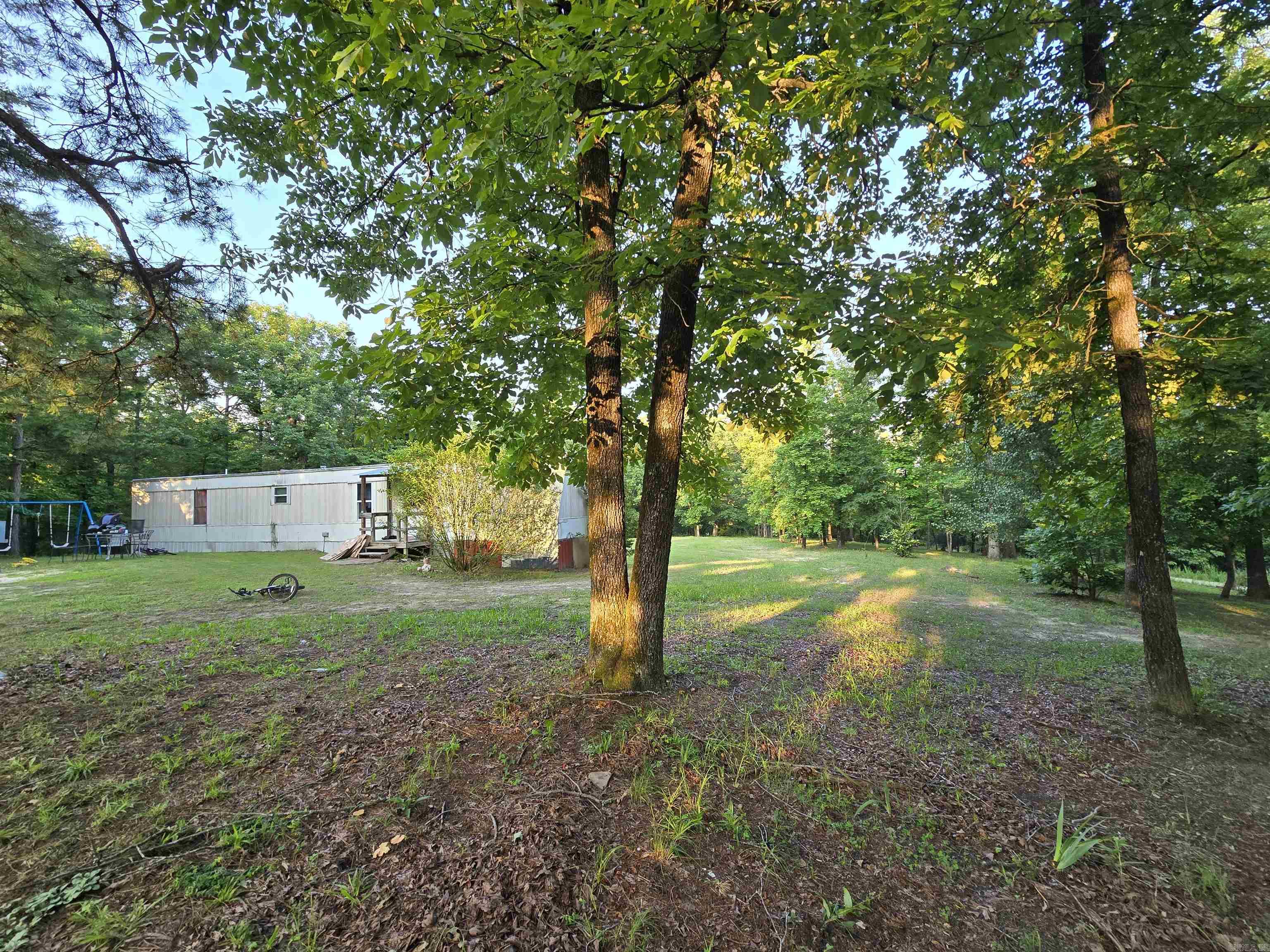 This mobile home offers a peaceful, private setting, just minutes from Lake Norfork and the White and Norfork Rivers. With 924 sq. ft. of living space, it provides comfortable accommodations in a serene location. The property also includes a storage shed for added convenience and a lean-to for additional outdoor storage. Whether you're seeking a weekend getaway or a cozy permanent residence, this home offers both practicality and a tranquil retreat. Priced at $75,000, it's an excellent opportunity to enjoy the natural beauty of the area with all the essentials at your fingertips.