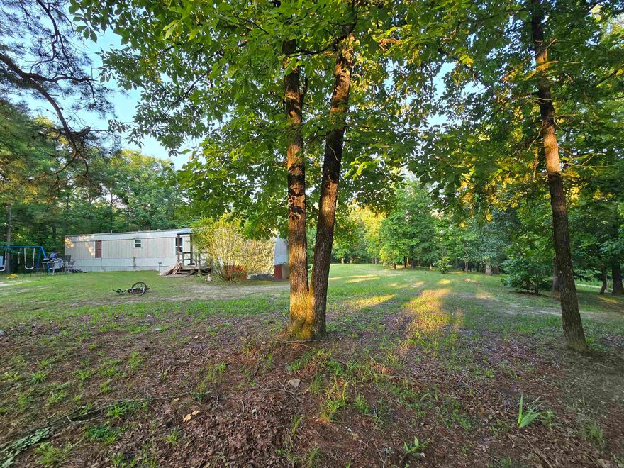 This mobile home offers a peaceful, private setting, just minutes from Lake Norfork and the White and Norfork Rivers. With 924 sq. ft. of living space, it provides comfortable accommodations in a serene location. The property also includes a storage shed for added convenience and a lean-to for additional outdoor storage. Whether you're seeking a weekend getaway or a cozy permanent residence, this home offers both practicality and a tranquil retreat. Priced at $75,000, it's an excellent opportunity to enjoy the natural beauty of the area with all the essentials at your fingertips.
