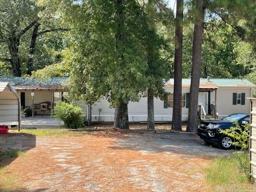 Take a look at this property that features two mobile homes, shop, storm shelter and sits on almost two acres!  The two mobile homes are currently rented and have had long term tenants making it perfect for investors or an opportunity for a large family needing two separate homes. The home closest to the street is a 3 bed 1 bath and is currently rented for $850.00 monthly. The home in the back is a 2 bed 2 bath with a large deck that has a very private view of the woods and it is currently rented for $950.00 monthly. There is also a 34x36 concrete block shop that sits between the two homes that could be used for storage or additional rent.