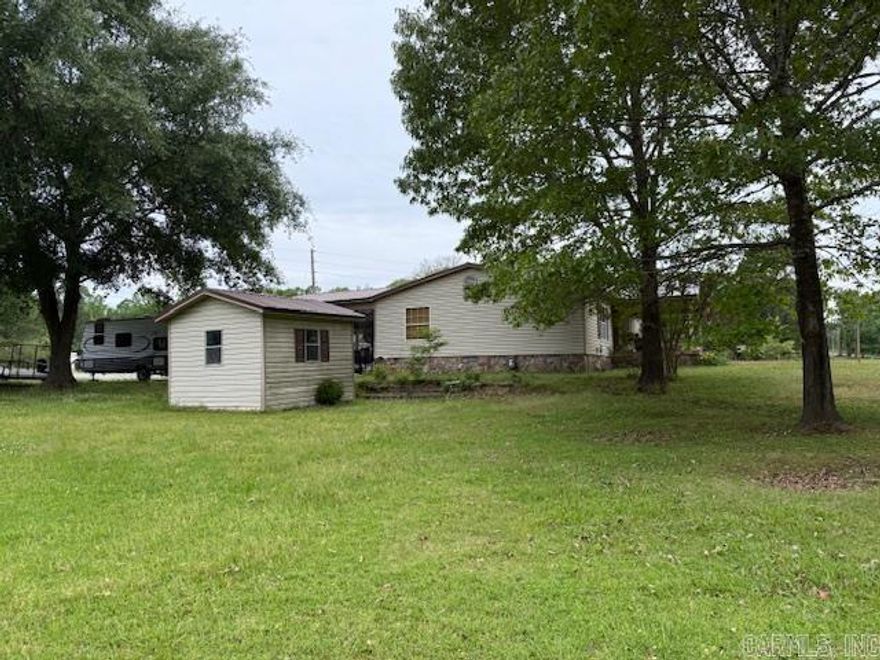 Two Dwellings on this property.  An amazing double wide home which has been modernized and a 1200 square foot metal building completely finished on inside to include bedroom, bath and kitchen  Property is both pastureland and timbered.