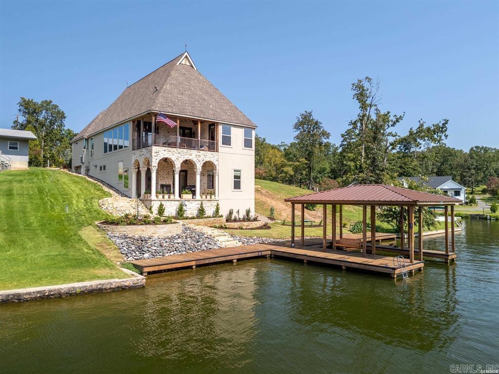 Nestled just moments from the renowned Hot Springs Country Club, this beautifully custom-built lakefront home offers a perfect blend of luxury, comfort, and convenience. With 4 spacious bedrooms and 3.5 elegant baths, this home is a serene escape with all the modern upgrades already in place. Recent Enhancements (2024): New roof for long-term peace of mind New upstairs A/C, tankless water heater, and gutters Fresh interior paint throughout for a crisp, clean aesthetic Remodeled primary bath and updated shower/plumbing downstairs Professionally double-insulated attic for energy efficiency Modern Gourmet Kitchen: Sleek new stovetop and Bosch dishwasher Stylish undercounter lighting and updated interior lighting for a warm, contemporary feel Outdoor Amenities: Brand-new boat dock and boardwalkāperfect for lake living Fresh landscaping frames the property with natural beauty Expansive waterfront views that will take your breath away every single day Entertainerās Dream: Full second kitchen downstairsāideal for hosting or multi-generational living Located in one of Hot Springsā most desirable neighborhoods, this home brings together premium upgrades in an unbeatable location.