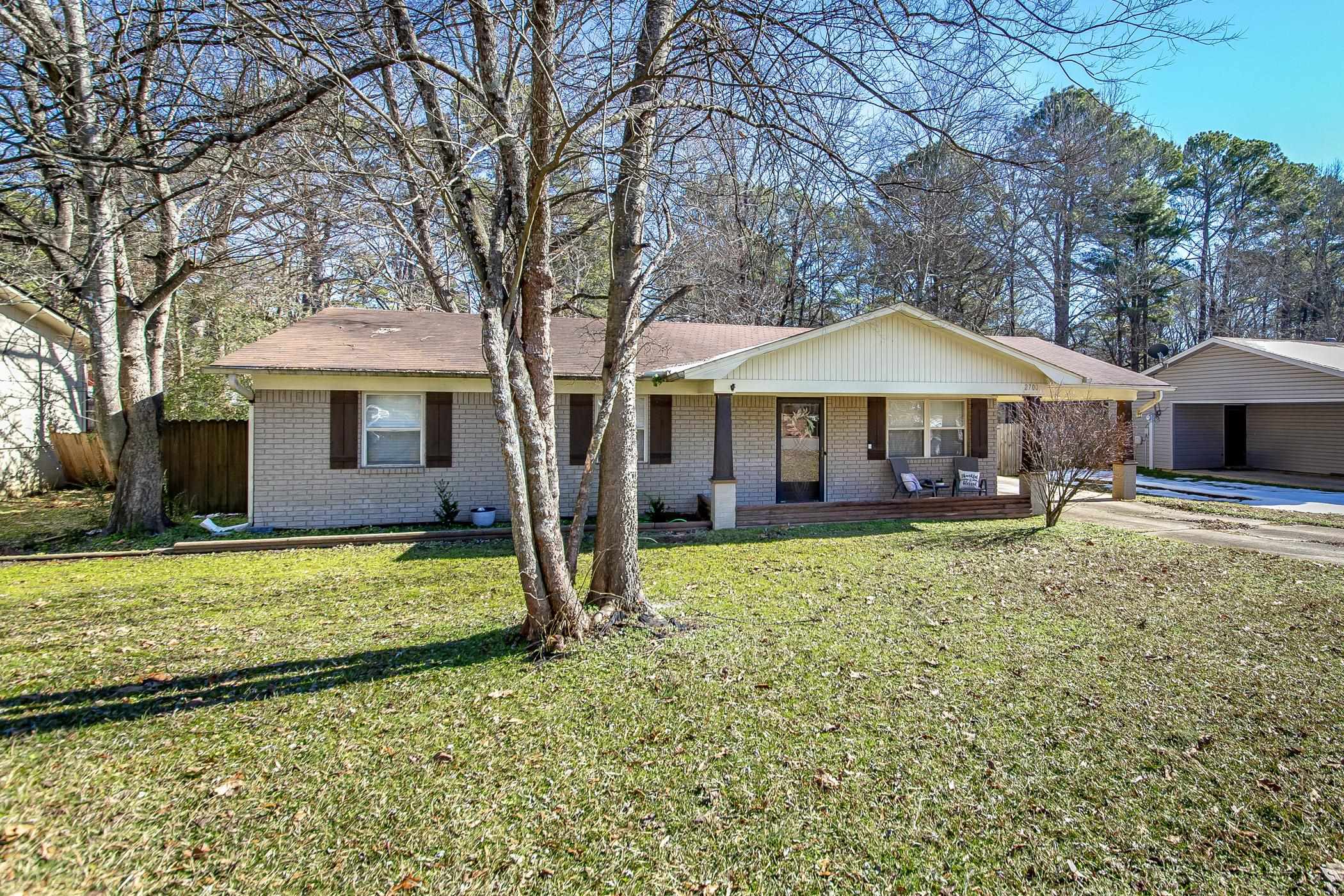This cozy 3-bedroom, 1.5-bath home is warm and inviting, featuring crown molding and luxury vinyl plank flooring throughout. The large family room offers plenty of space to relax, while the spacious primary bedroom provides a peaceful retreat. The kitchen is beautifully updated with a tile backsplash, under-cabinet lighting and a gas stove. the bathroom showcases a custom title surround tub/shower and plenty of storage. Outside, enjoy a big fenced backyard with a mature tree and a covered patio, perfect for relacing or entertaining. Complete with gutters, a carport with storage, and a charming front porch, this home is a must see!