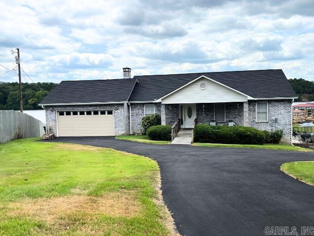 Discover an extraordinary opportunity on the serene shores of Lake Hamilton! This unique property offers not one, but two separate living spaces, each with its own private entrance and no internal access between. This setup is ideal for a variety of uses: an investment for short-term rentals, a lake home, or a primary residence. Both levels boast stunning, abundant lake views! The upper level is spacious featuring three bedrooms and two baths. Relax in the jetted tub or refresh in the walk-in shower. The hardwood floors add a touch of elegance, while the fireplace provides a cozy ambiance. Step out onto the massive deck to soak in the panoramic lake views. The lower level, accessible conveniently from the side with itās own parking, is equally inviting with two bedrooms, one bath, kitchen, and laundry. The living room, complete with a fireplace, opens to a covered patio where you can unwind and enjoy the peaceful surroundings. Enjoy swimming from the covered dock or embark on lake adventures in the boat which will convey with an acceptable offer. Recent improvements include a new roof for both the house & dock, gutters, siding, paved asphalt drive, and a new garage door.