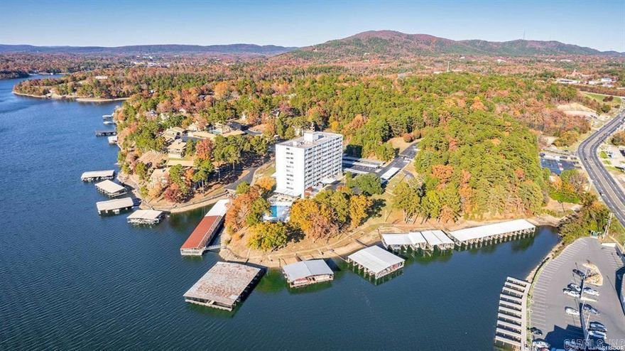 Affordable low price for this cheerful, light filled lake Hamilton condo in a great location. The balcony has been enclosed to become a sun room / bonus room.  The cheerful kitchen has granite counters.  All appliances are included.  The walk in closet is quite large.  The condo was recently repainted and a new hot water heater was added.  The low POA fee includes water & sewer, trash, building insurance (common areas, exterior, hallways), grounds, pool, gate, tennis and pickleball court, landscaping, and a professional building manager.  The building also has electronic access for added security. All this and a convenient location, beautiful grounds, and covered parking. Much to like here!