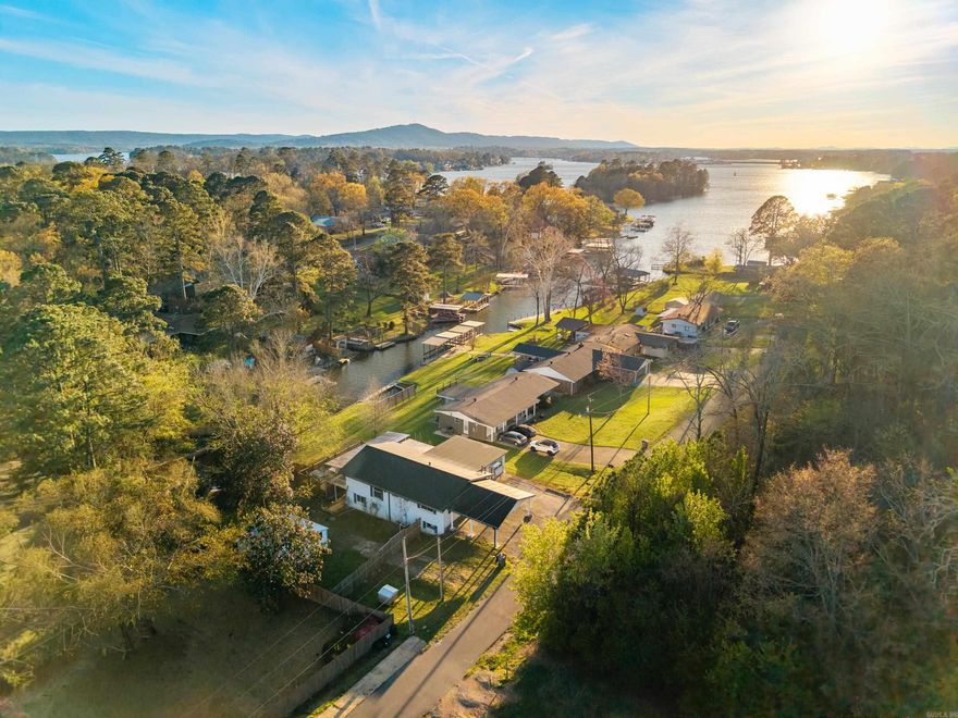 Lakefront home on Lake Hamilton offering over 3,000 sq ft, 4 bedrooms, 3 bathrooms in a peaceful cove setting with a covered boat dock. This spacious property features multiple living areas, a lower level with kitchenette, and a large deck perfect for entertaining. Recent updates include a new roof and gutters, all new crown molding and trim, new fence, new carpet, gas fireplace, and much more! Located right off Central Avenue, this home is minutes from everything Hot Springs has to offer. Call today to schedule your showing!