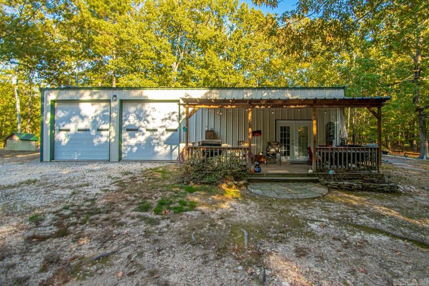 Come check out this Barndo/Shop Combo!! 750 Sqft. living quarters with 750 Sqft. of shop space. Also a 18x36 3 Car and RV Storage area. Beautiful property with 4 acres of forest land. Perfect land for new construction or development in a high growth area in the Bryant Community!!