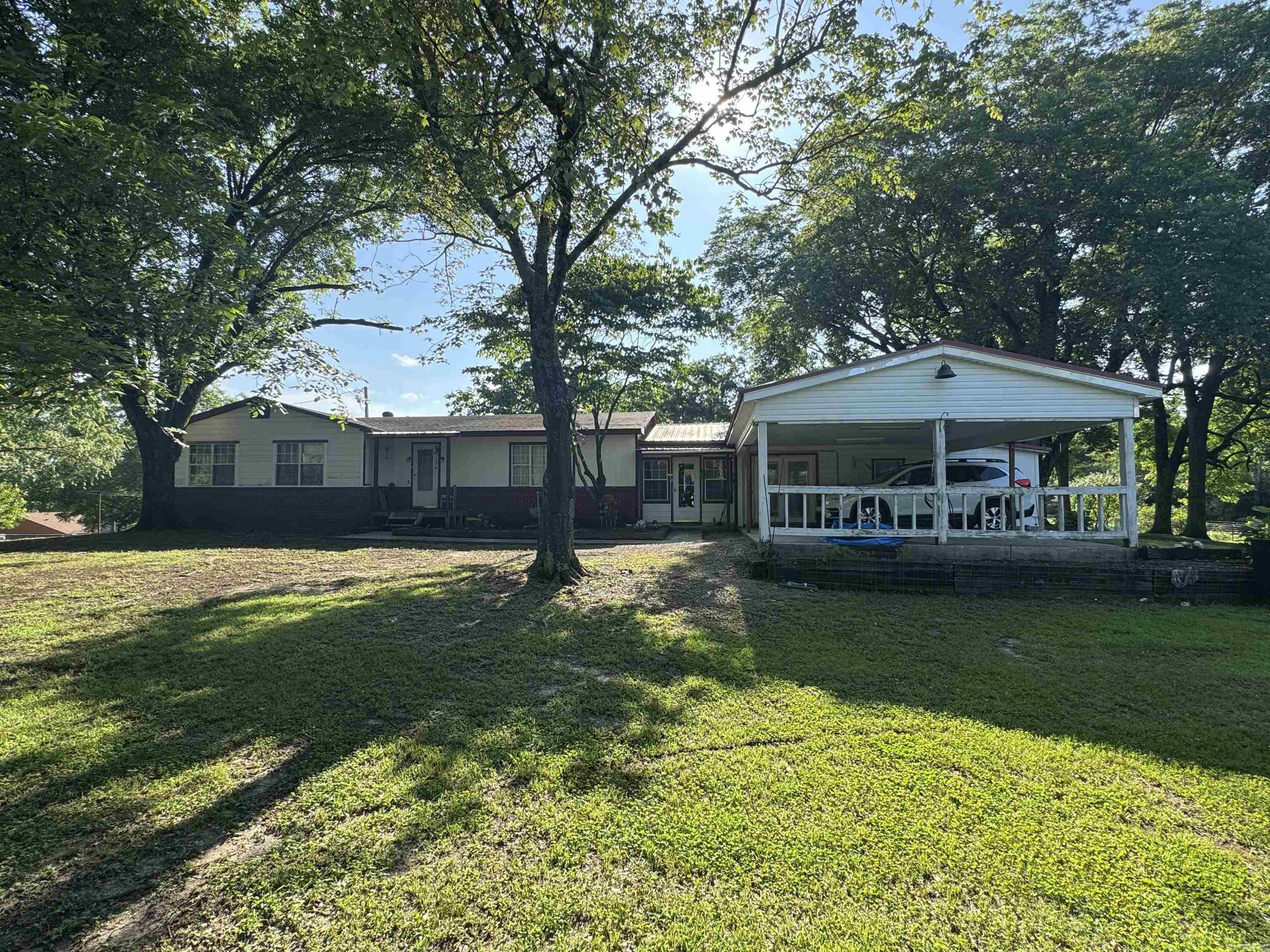 This 10-acre property in Wickes, Arkansas offers a rare mix of space, convenience, and functionality with highway frontage and a wide range of features for country living. The 4-bedroom home includes 1 full bath and 2 half baths, providing ample room for family or guests. Outdoors, you'll find multiple established gardening areas with producing blackberry and blueberry bushes, as well as fruit trees already bearing. A greenhouse extends your growing season, and a covered barn adds flexibility for equipment, storage, or livestock use. The property also includes two outdoor storage areas and two separate shedsāone of which has electricity, and an electric vehicle charger. A large shop is fully equipped with water, electricity, a wood-burning stove, and its own bathroom, ideal for projects, hobbies, or workspace needs. There's also a chicken coop with electricity and water, a storm shelter for added safety, and an existing well (currently not in use). With easy access off the highway and a well-thought-out layout, this property offers both practicality and room to grow.