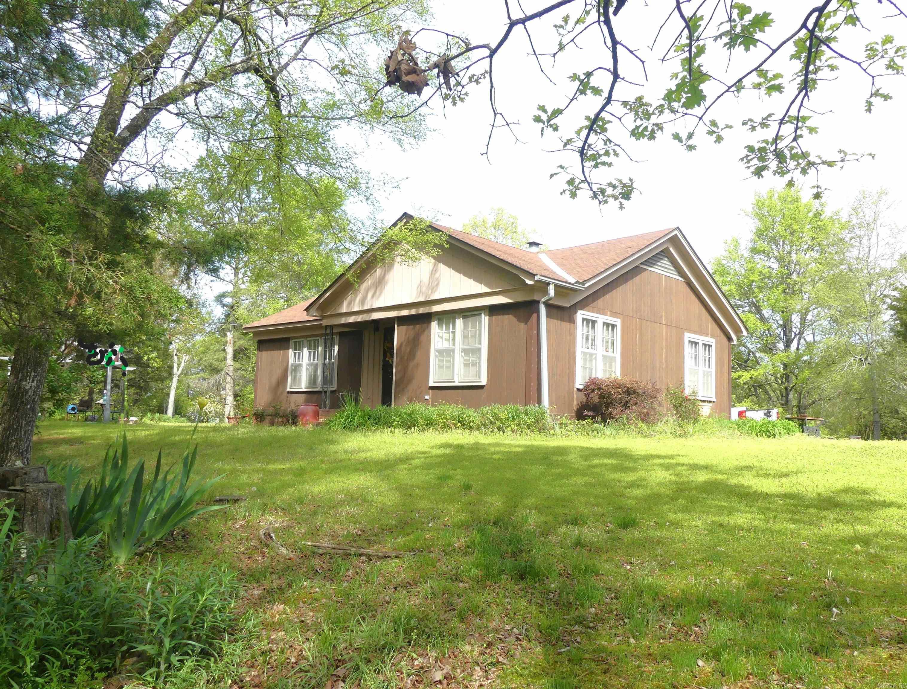 Unique property! Beautiful, peaceful and private 5.64 acres with a lovely 2 bedroom, 1 bath home in Morrilton City limits. This hilltop retreat has a private drive leading up to the charming, well built, older home.Ā This property includes mature trees, pasture and an antique barn.Ā A perfect Hobby Farm with room for a few horses and other animals, garden spaces or just enjoy the wildlife, sunrises and sunsets in your own private oasis. Property includes an older, well built home (2 bedroom, 1 bath) with original hardwood floors. There is a 30 ft x 30 ftĀ carport with 180 sq ftĀ storage and a small, historic split level barn. The homesite is very conduciveĀ to expansion/addition if you need more living space. There is also aĀ separateĀ half acre lotĀ with all utilityĀ hookups on site for a separate residence, investment property or keep it to add more privacy. The locationĀ is private and just off Hwy 64 west in Morrilton. 5 minutes to I-40 makes for easy access to all of Central Arkansas. Call today to take a tour!