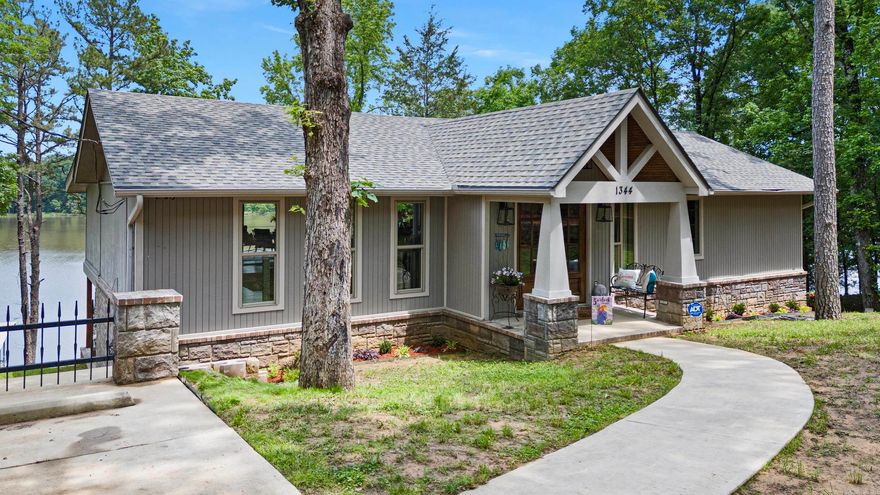 Welcome to this inviting Lake Dardanelle retreat, a stunning haven offering the perfect blend of comfort and luxury. Spanning 3364 square feet, this stunning lake house is designed to accommodate families and guests with ease and style. Upon entering, you're greeted by a spacious and airy living area, seamlessly connected to the dining space and kitchen. The open-concept layout creates an inviting atmosphere, ideal for entertaining or simply relaxing with loved ones. Natural light floods the interior, highlighting the tasteful finishes and attention to detail throughout. The heart of the home is undoubtedly the kitchen, where form meets function. Boasting not one, not two, but three kitchens, including two indoor kitchens and an outdoor kitchen.  The master suite is a sanctuary unto itself, offering a private retreat for homeowners. The ensuite bathroom features double sinks, a luxurious soaking tub, and a dual shower with dual heads, creating a spa-like experience at home. In conclusion, this Lake Dardanelle retreat is more than just a home, it's a lifestyle.