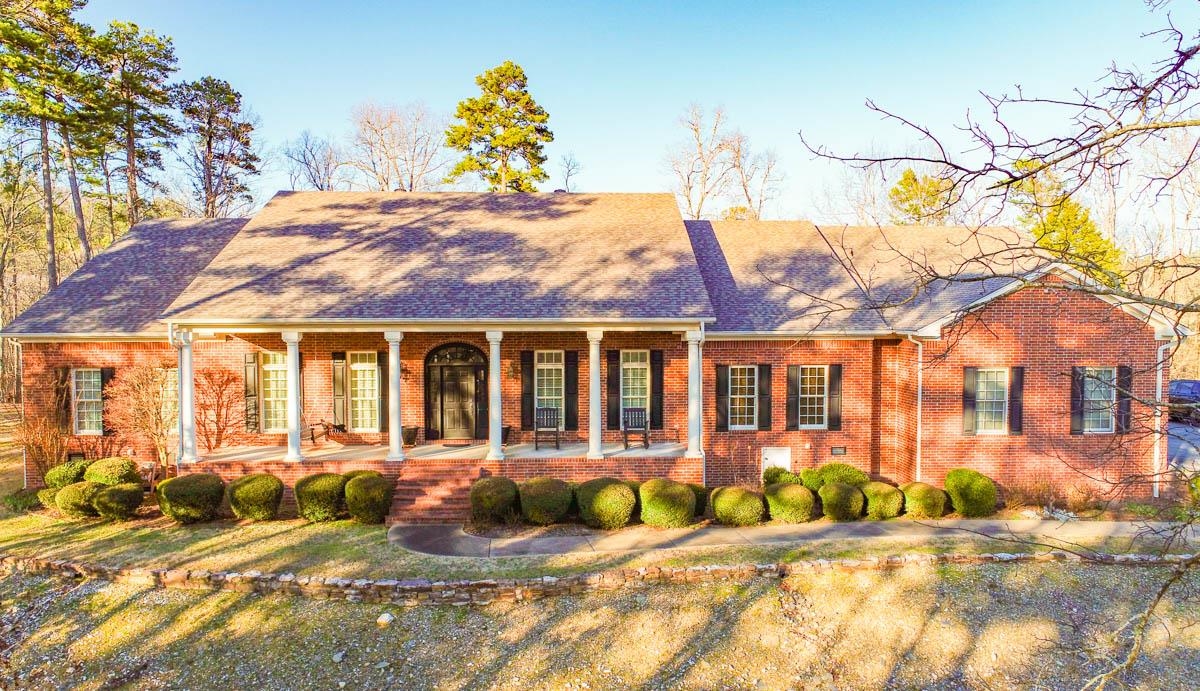 Private 16.5 +/- acres with gated entrance, city water and multiple homesites. Home is in excellent condition with large rooms, hardwood floors, crown molding, two fireplaces; one in the Living Room and one in the Den. Heated and Cooled Sunroom with access to the back patio, large open kitchen with breakfast area and Butler's station, large pantry, formal dining room, private library/office, Primary bedroom has a small room that can be used as nursery, office or workout area. Upstairs has one bedroom and bath, giant game room with surround sound and projector. Three car garage includes a shop area with sink. Beautiful property - come see today!