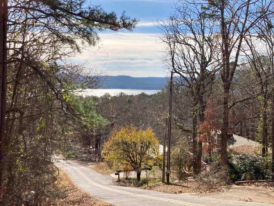 Discover your piece of paradise nestled in the Ozarks in stunning Fairfield Bay, Arkansas! This partial, seasonal LAKEVIEW, oversized-double lot, located just minutes from the full-service marina on Greers Ferry Lake presents an ideal opportunity to construct your dream home in a highly sought-after locale, complete with a plethora of amenities.  This property perched atop the corner of Hilltop Dr. and Hillcrest Dr. offers a partial/seasonal view of stunning Greers Ferry Lake which is a haven for fishing enthusiasts, boating aficionados, or those who simply cherish waterside serenity. Fairfield Bay doesn't stop there; it boasts an array of facilities, including three swimming pools, two 18-hole golf courses, extensive hiking and biking paths, ATV/UTV trails, pickleball and tennis courts, and more. Whether it's outdoor excitement, a sociable tennis match, or a tranquil day poolside, Fairfield Bay caters to all. Surrounded by nature, but only 90 minutes to Little Rock, this could be your own little Ozark oasis. These are currently two separate lots with two parcel ID numbers.