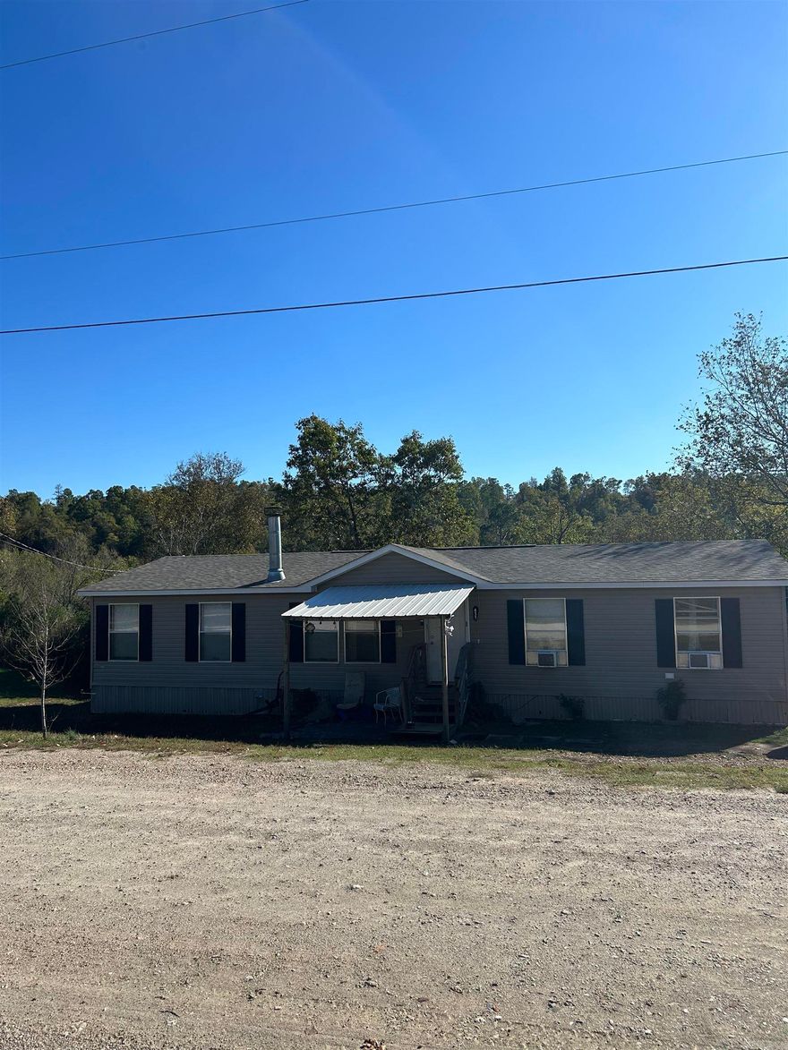 4 bedroom, 2 full bath home on one acre that sits on Hallman's Creek.  Brand new roof.  New appliances.  Wood burning fireplace.  Pantry.  Landry.  Survey available. Qualifies for USDA loan. On permanent foundation.  Beautiful views of the creek.  Out of city limits.  Lake Hamilton school district.  Sellers offering a $5,000 paint and flooring allowance with acceptable offer.