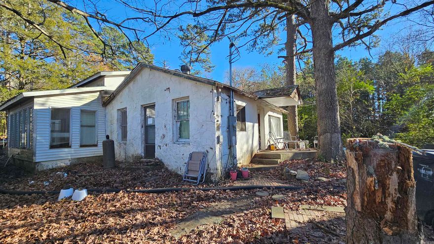 Imagine living upon a generous 1.81-acre parcel of land with steady water flowing from the mountains and beyond the bustling city limits, this 2-bedroom, 1-bathroom home presents an exciting opportunity for those with a vision for transforming a fixer-upper into a dream retreat. Though in need of tender loving care, this property offers ample potential for creative restoration and customization.  Roof recently repaired and new metal roofing has been added.