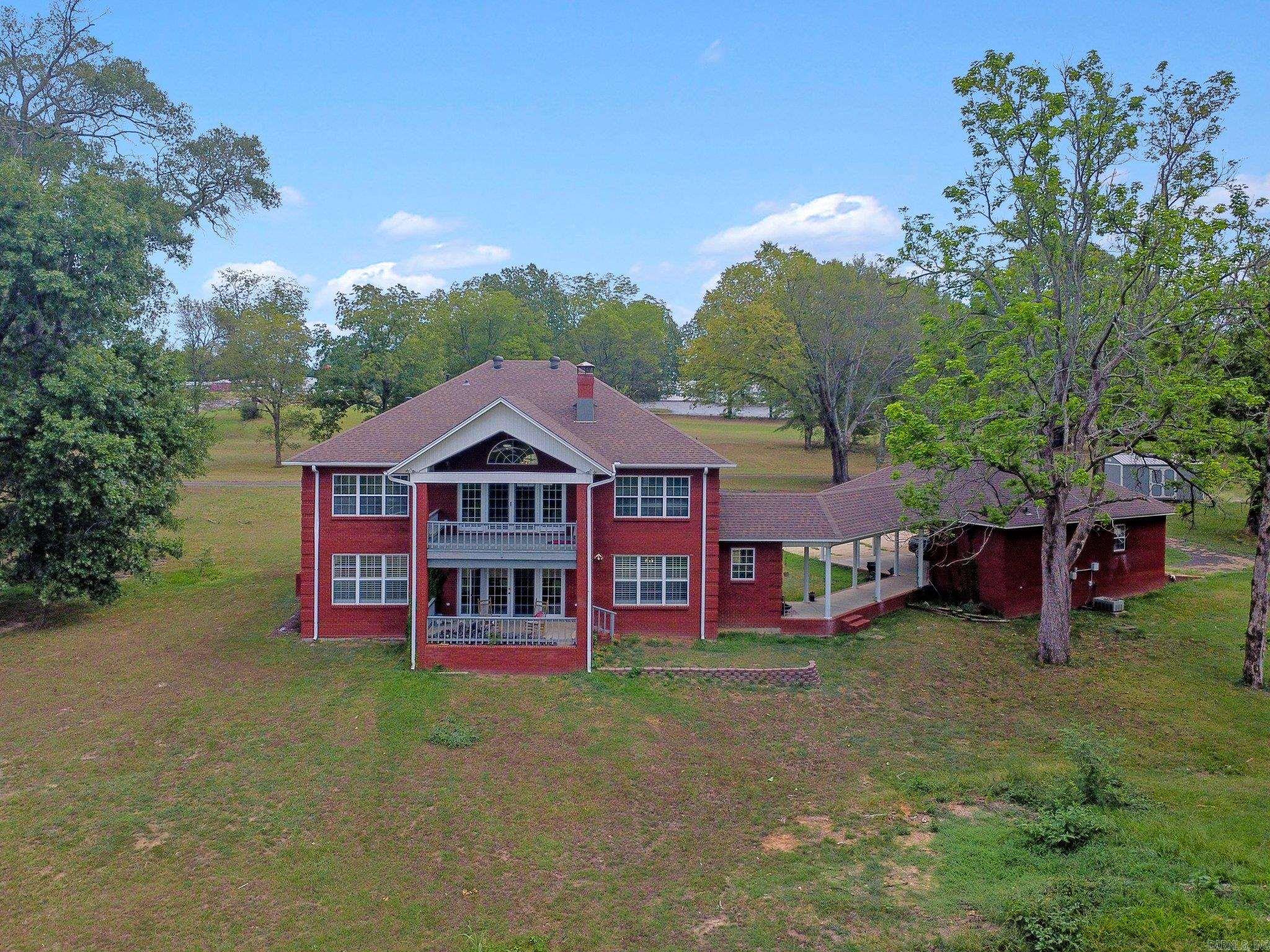 Welcome to this magnificent all-brick home that boasts a grand foyer and the perfect blend of elegance and comfort. The versatile floor plan offers a primary bedroom that can be situated on either the lower or upper level, according to your preference. Each of the spacious bedrooms have large walk in closets for abundant storage and ample additional storage areas throughout. The roomy kitchen has brand new quartz countertops and new cook top as well as double pantries. There are two laundry rooms (one on each level) and a half bath for guests on the lower level. Step outside to enjoy the tranquility of the river from either of the two back porches overlooking the backyard, with easy access to the river for endless outdoor activities. Detached garage offers space for a workshop and additional living quarters, if desired. Recent upgrades include new plantation shutters throughout the lower level and new carpeting in all bedrooms, stairs and upper living area. The home also offers both a newly installed roof and new AC unit in 2021. Would make a fantastic AirBnB! Come and experience this property on the scenic Ouachita River and make it your perfect retreat.