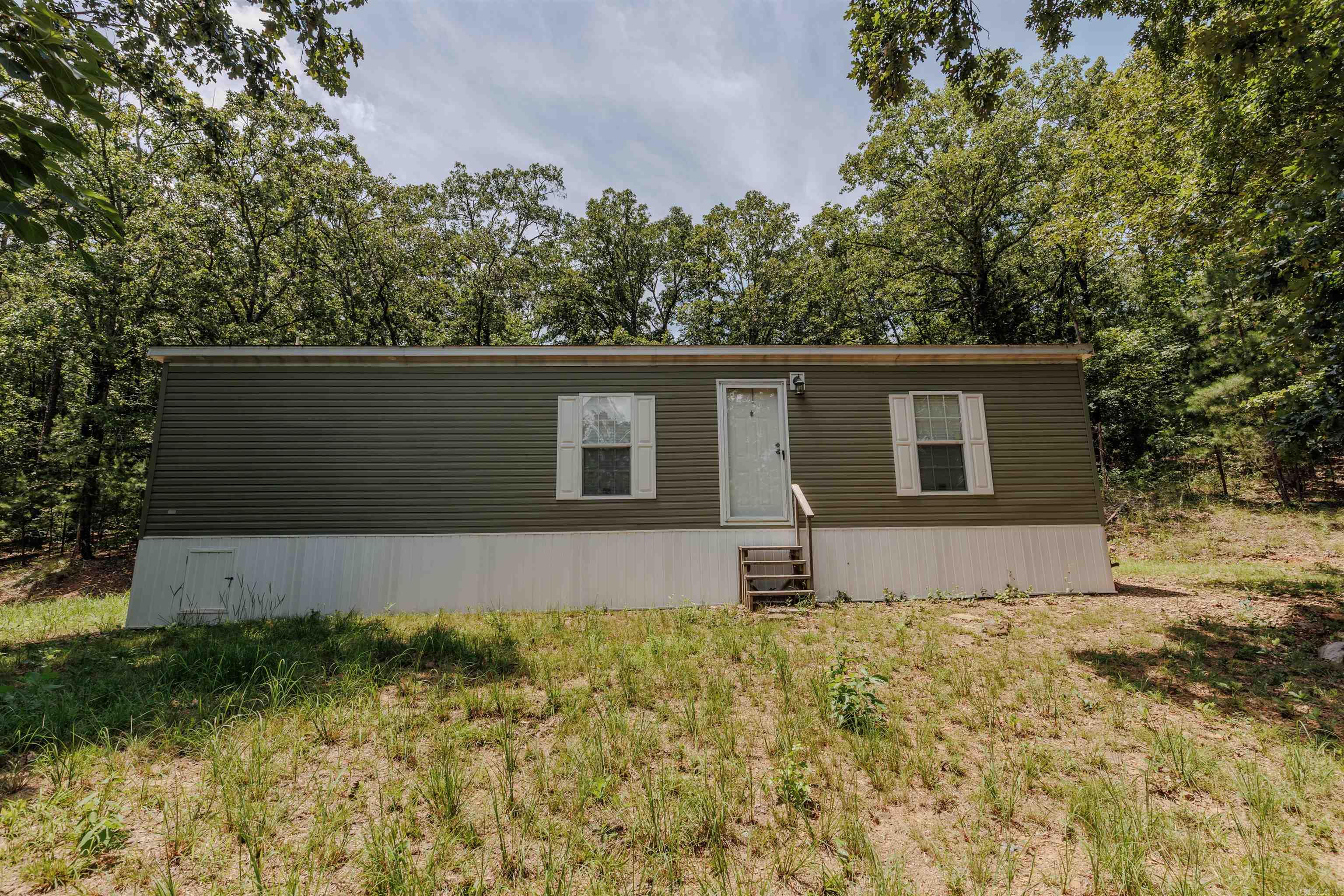 Like-new manufactured home built in 2019, barely lived in and nestled on 1.8 private acres surrounded by woods! This home sits on a permanent foundation with tie-downs and offers seclusion while still being conveniently located between Russellville, Conway, and Little Rock. Fiber internet available through Connect2First. Move-in ready and waiting for you to make it your own! Qualifies for USDA Rural Development financing with 0% down payment. Contact your preferred lender for pre-qualification and more details!