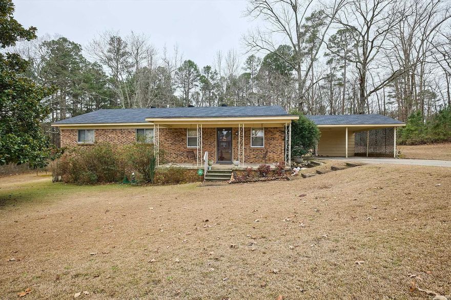 This charming home offers a serene retreat in a coveted location. Boasting three bedrooms and 1 1/2 baths, this property has so much potential! As you step inside, this home welcomes you with it's warmth and charm and is a perfect canvas for your own style. The two car carport adds convenience and shelter. While the home could use some updating, it offers endless possibilities and the location provides both privacy and accessibility to shopping, schools, and recreation.