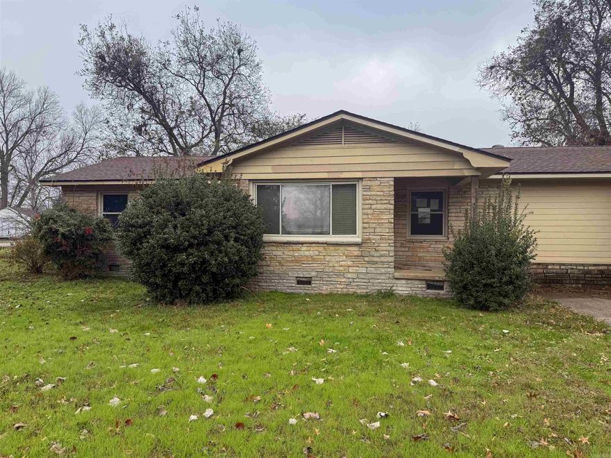 Investor or rehab opportunity. This single-story home offers 3 bedrooms, 2 bathrooms, and two living areas including a living room and separate den. The front elevation features a fieldstone veneer, complemented by brick and siding exterior elements. Situated on a corner lot, the property includes a chain-link fenced backyard and multiple unique built-ins throughout. The galley-style kitchen with pantry is in need of significant rehabilitation and offers an opportunity for customization with vision and creativity. Seller makes no warranties regarding the condition or functionality of the electrical or plumbing systems, existing appliances, or fireplace. Property is being sold as-is.