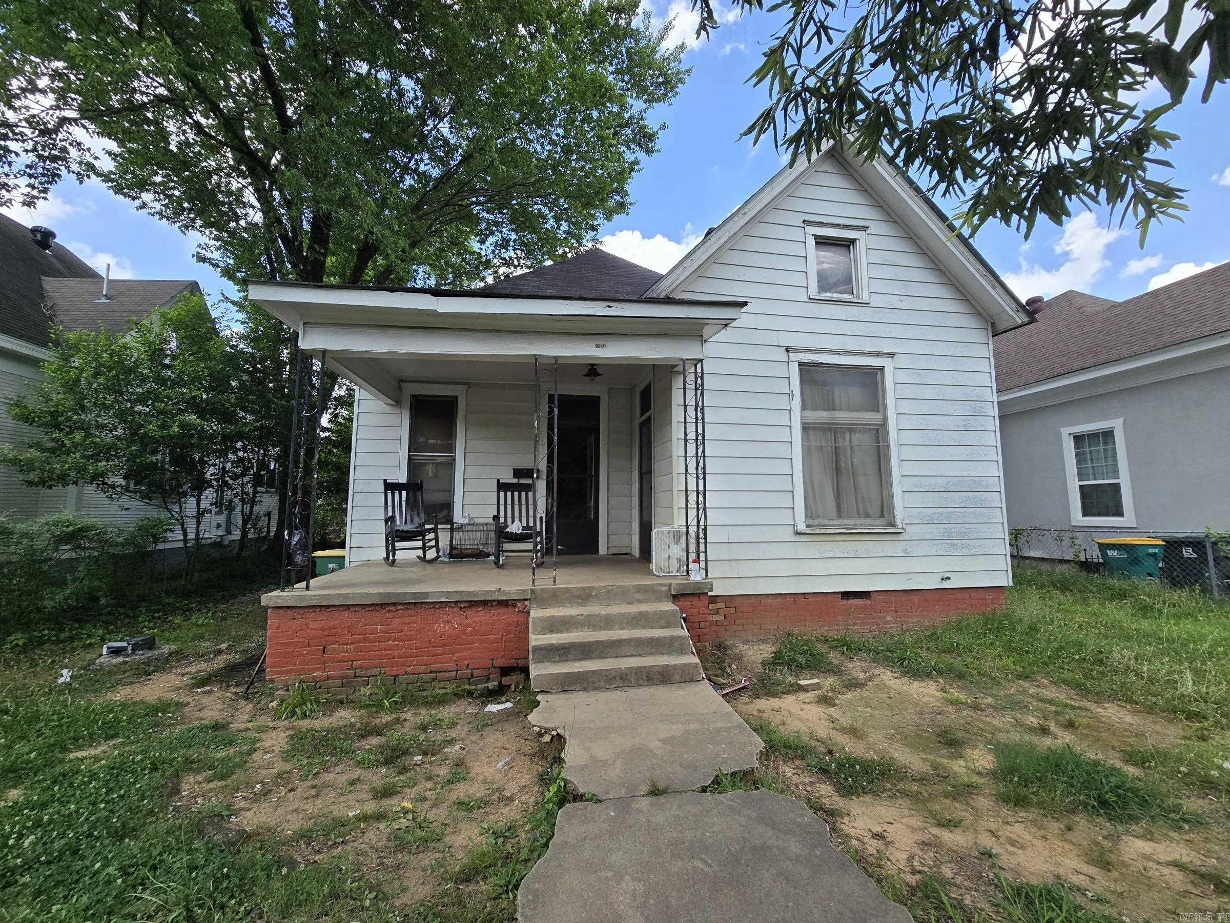 A neat, historical house looking for someone to pour some love into it! This house has 3 beds, 1 bath, and 12' ceilings. When you walk onto the front porch, there is a side entrance to the front bedroom and a front door that leads into the parlor. Moving beyond the parlor, you'll walk into a room that could used as a family area or dining room. This room splits off to a hallway with 2 bedrooms and a bathroom and the kitchen is split off on the right. Another room connects to the kitchen that could be used as a study or family room. This study/family room leads into the front bedroom. There is a staircase in the study/family room that leads to the attic for easy, walk-in storage. Some of the transom windows are still intact and operational. The backyard is fenced in and has a private access road to get into it. So much character in this house, and it is ready for you to make it shine! Agents, see remarks for important info.