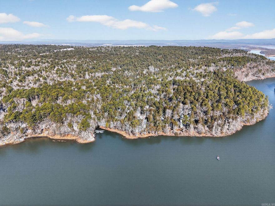 Discover a unique chance to own three connected lots on Lake Dardanelle totaling approximately 6 acres in the peaceful community of New Blaine, Arkansas. The parcels include 3.27 acres, 2.22 acres, and 0.5 acres, offering flexibility for a variety of uses—whether you’re dreaming of a private lake retreat, multiple homesites, or a long-term investment.  Enjoy the beauty and recreation Lake Dardanelle is known for, including fishing, boating, and stunning waterfront views. The combined acreage provides ample space for privacy while still allowing room to develop, subdivide, or hold as a legacy property. With road frontage at Boyd Rd and a scenic lakeside setting, this property offers the perfect balance of accessibility and tranquility.  Opportunities like this—multiple adjoining lots on the lake—are increasingly rare. Build now or secure the land for future plans and enjoy all that lake life in the Arkansas River Valley has to offer.  Don’t miss this exceptional Lake Dardanelle property—schedule a showing today.