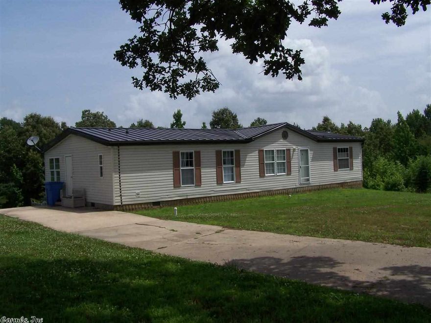 1568 sq ft double wide setting on 7.8 acres.  26 X 32 garage/shop  w/concrete floor, electric, 220 line, compressor goes with shop, paved road. Home has kitchen and breakfast nook, spacious great room and dining. Master bedroom, master bath. 2 guest bedrooms and hall bath.  Western Greene County water is available.