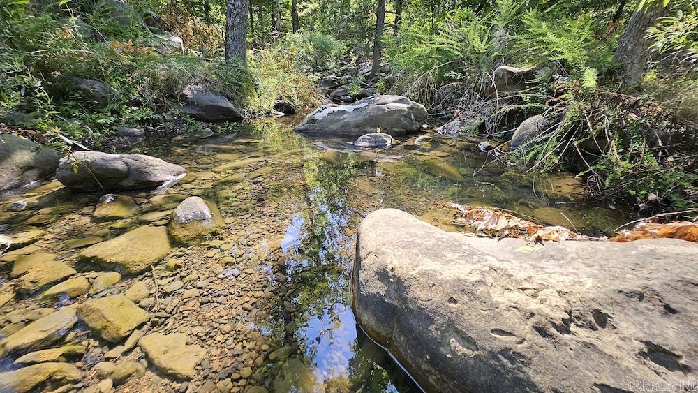 This wooded Ozark paradise is the ultimate private recreational and hunting tract. You wonāt believe the views, trail work, bluff line, massive boulders, hunting potential, springs, and more! The lay of the land is a picturesque representation of what the Ozark Mountain country is notorious for. The raw beauty is truly present on this wooded tract. With a fantastic new gravel drive meandering into the heart of the property, access is no issue. In a small clearing in the hardwoods, a newly constructed custom Yurt is complimented by a large deck and mountain views. The Yurt is simply gorgeous and provides a very comfortable and inviting stay in your new mountain mecca. There are ample windows, a skylight, an antique wood-burning stove, custom flooring, and more. Seize the chance to own a pristine Ozark paradise. Premium additional acreage is available for your dream project or investment! Call today to schedule your private showing.