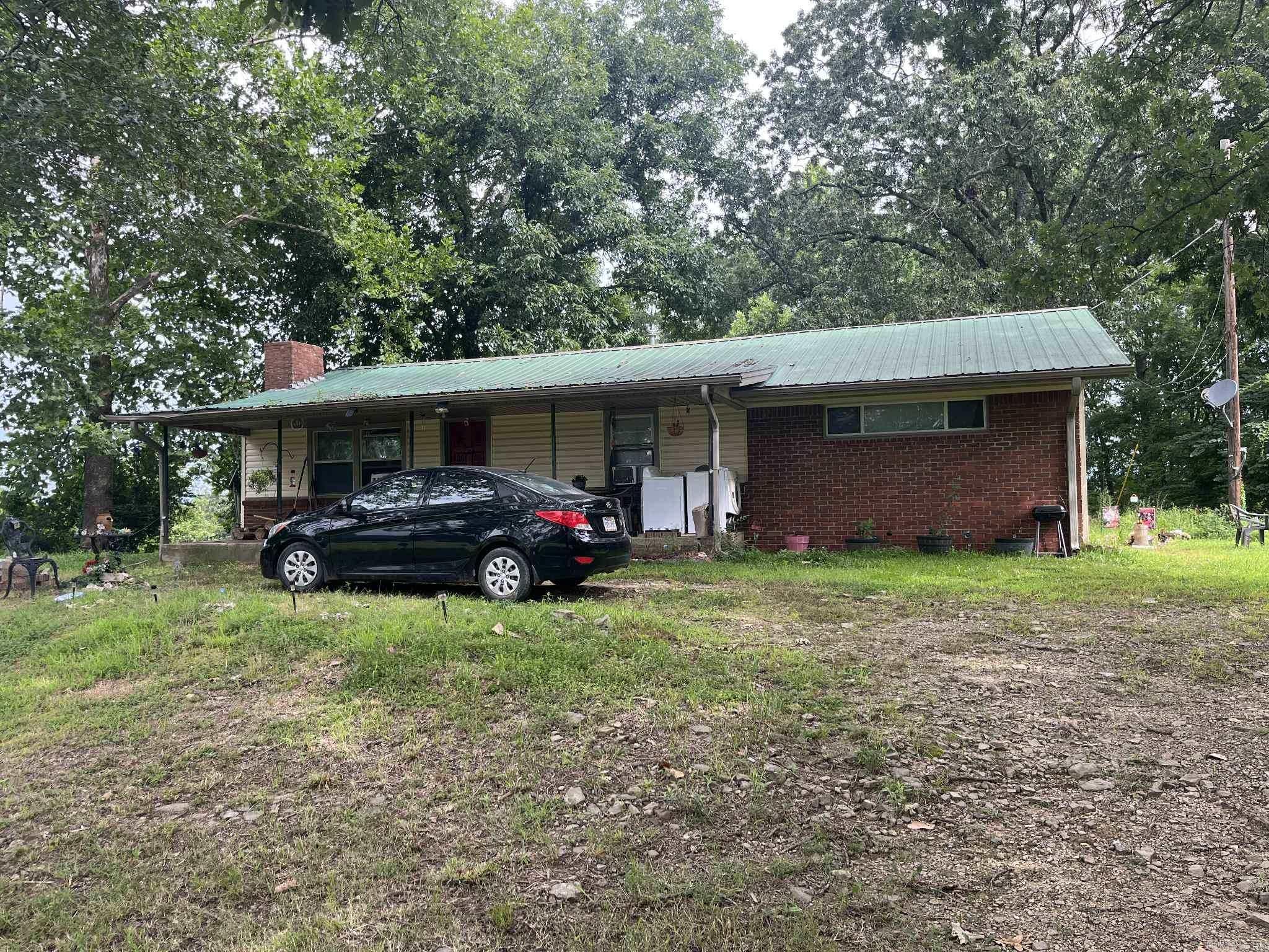 Cute 3 bedroom 2 bath just outside of city limits, 5 minutes from downtown Mena. Vinyl/Brick exterior with metal roof sitting on just under an acre.