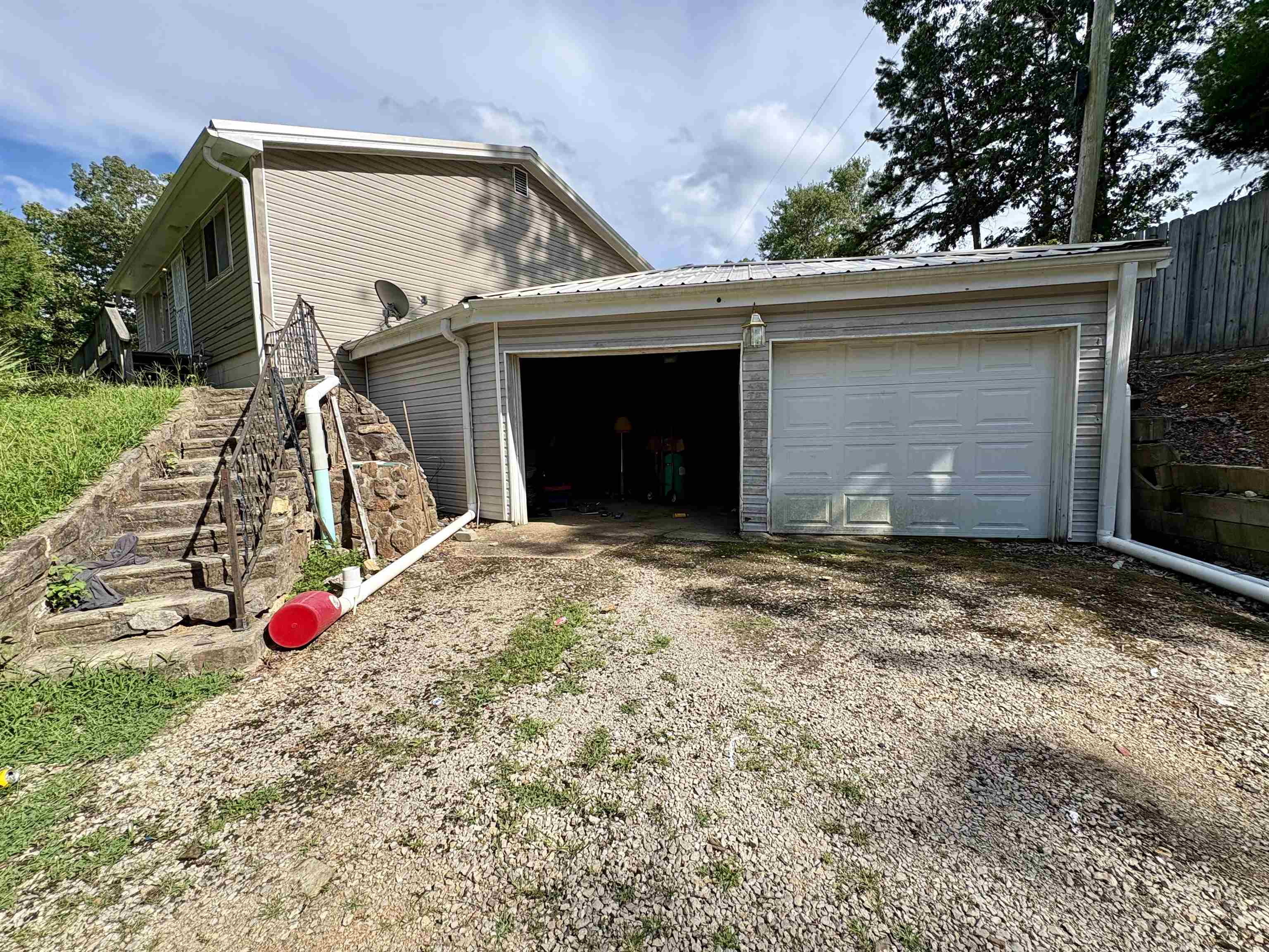 Nestled in the peaceful Ozark Acres community, this spacious two-story home offers comfort, versatility, and room to grow. With 2 bedrooms, 2 bathrooms, and two separate living areas, this property is perfect for multi-functional living. Inside, youāll find a walk-in shower as well as a big soaker tub/shower, two cozy fireplace inserts, and a large, light-filled addition that serves beautifully as a dining room, home office, or bonus space. The layout offers both openness and privacyāideal for quiet evenings or entertaining guests. Step outside to enjoy the partial wrap-around deck, overlooking a private yard with a large garden spot and three storage outbuildingsāone of which is nearly ready for use with only electric needing to be connected. The oversized two-car garage, along with a spacious private driveway, provides ample parking and utility space.This property offers both charm and practicality in a serene setting. Schedule your private showing today to explore all that 9 Summit Ridge Circle has to offer.